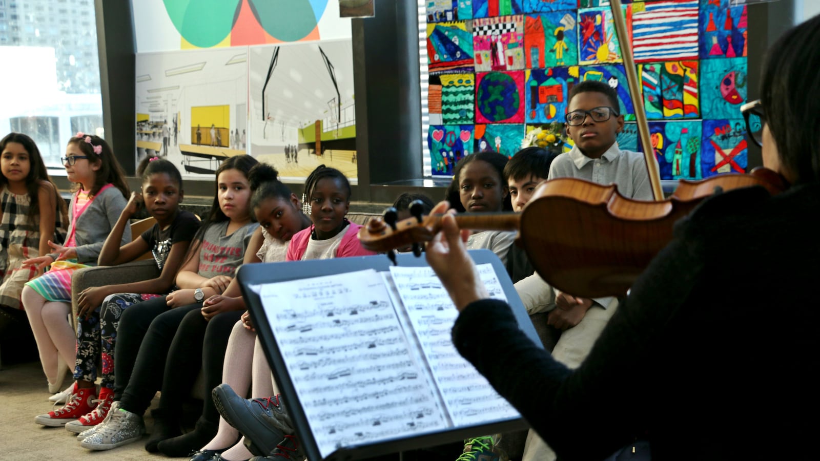 Students listened to their music teacher play violin at a P.S. 191 community event at Lincoln Center this spring. Fernando Taylor, a seventh-grade student who is the son of PTA President Charles Taylor, is seated far right. (Photo: Patrick Wall)