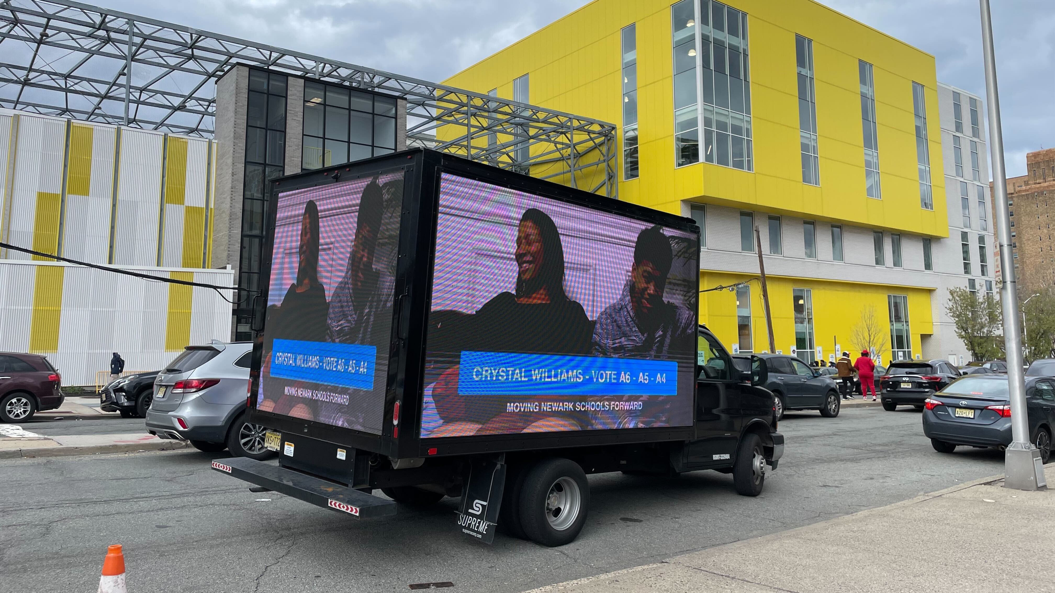 A truck displaying a video loop of newcomer candidate Crystal Williams, one of three on the Moving Newark Schools Forward slate, was seen parked outside of Lincoln Park High School, a North Star Academy school.
