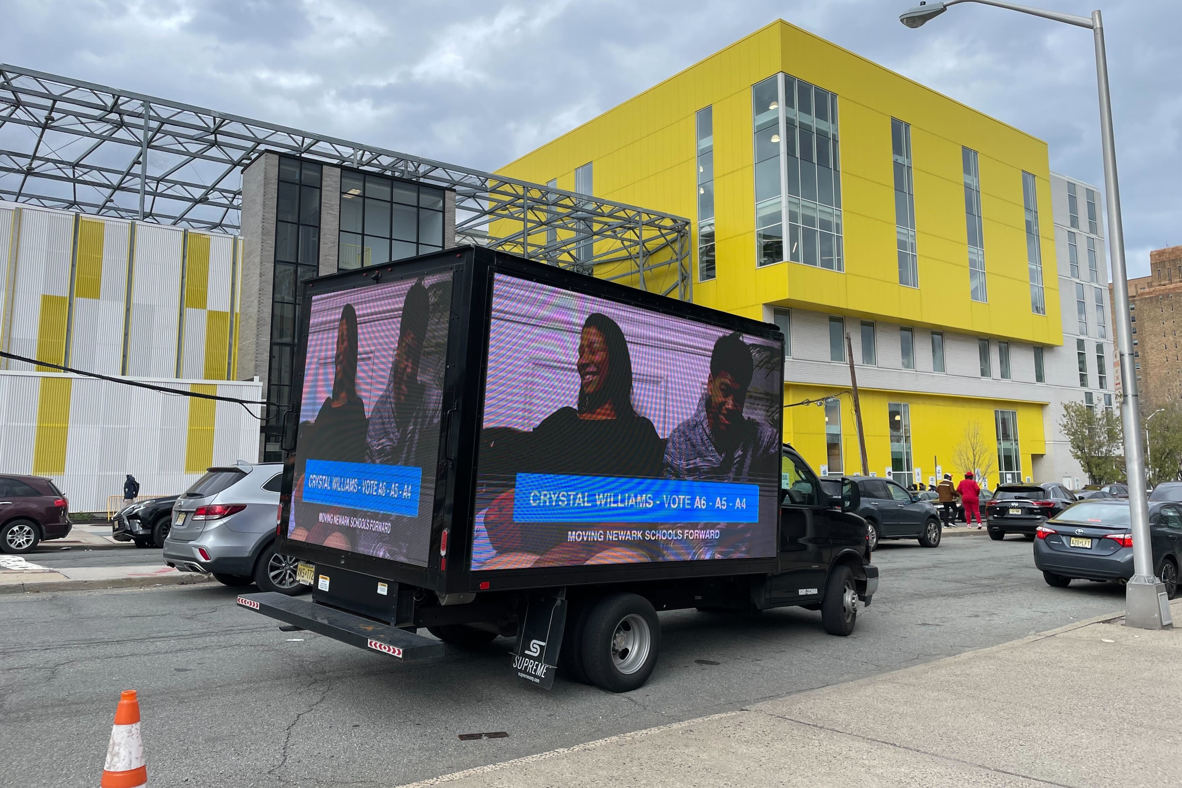 A truck displaying a video loop of newcomer candidate Crystal Williams, one of three on the Moving Newark Schools Forward slate, was seen parked outside of Lincoln Park High School, a North Star Academy school.