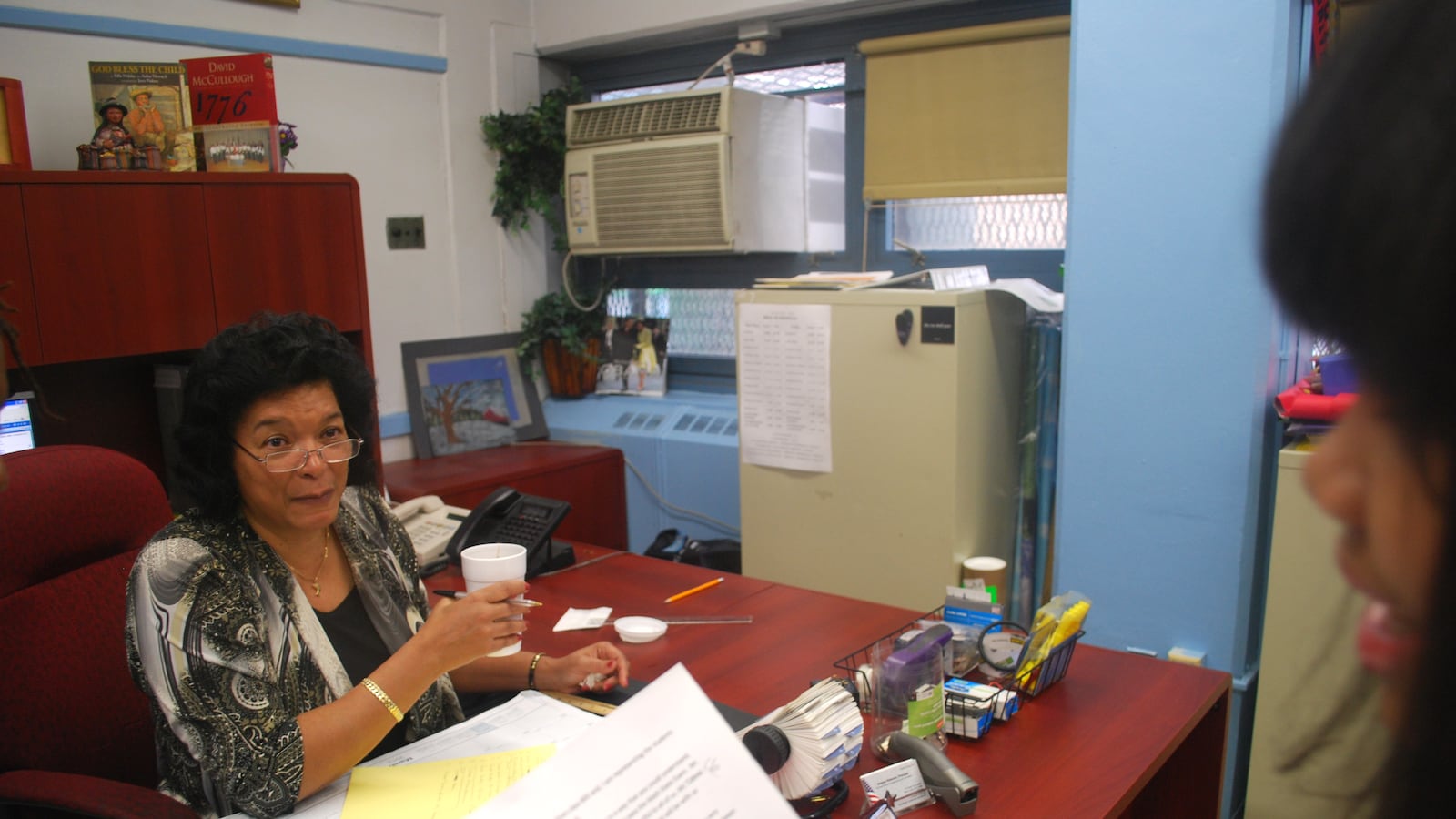 Dolores Peterson listens as one of her students goes over a speech she has written.