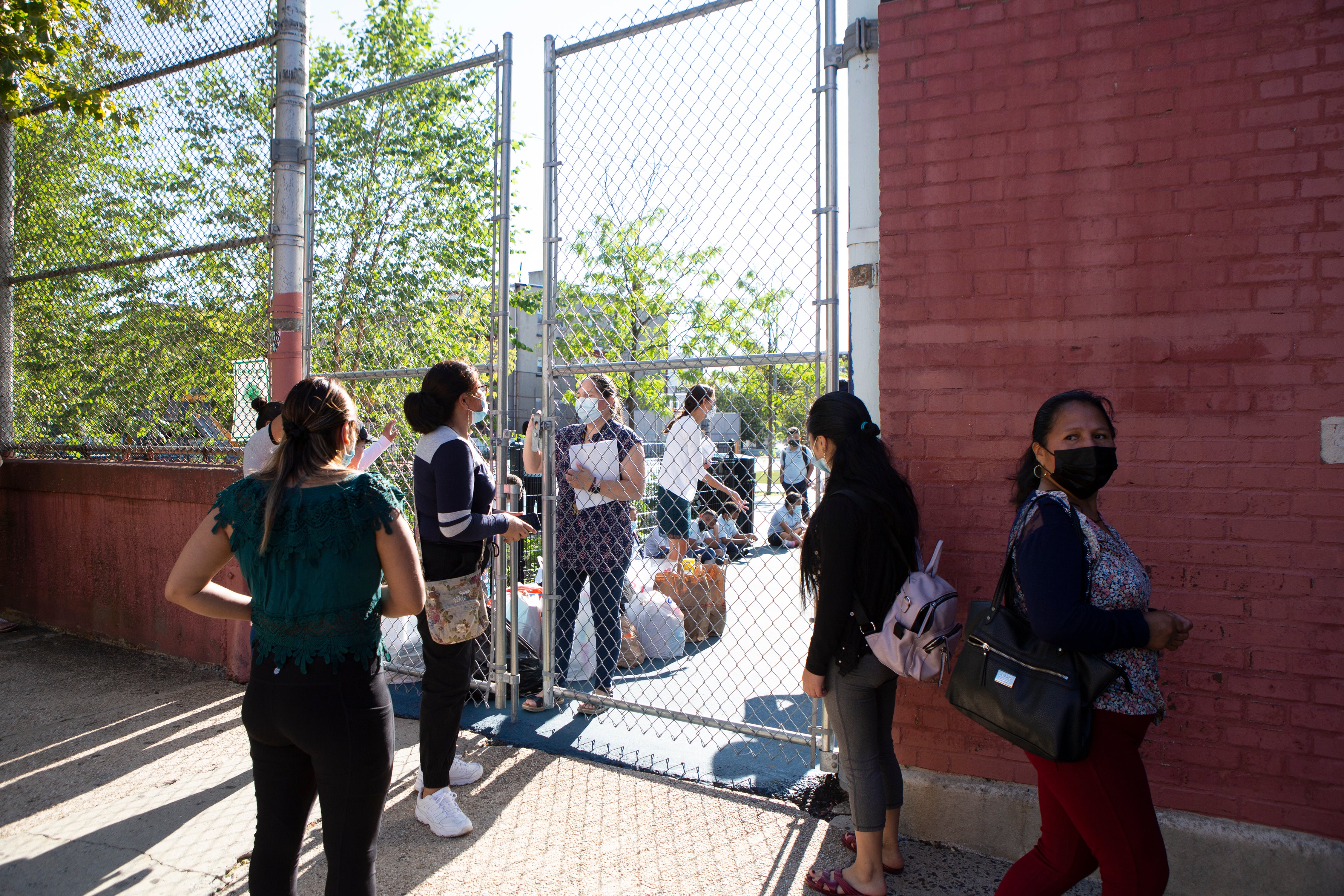 Several students and parents make their way into Newark’s Lafayette Street School on the first day of classes.