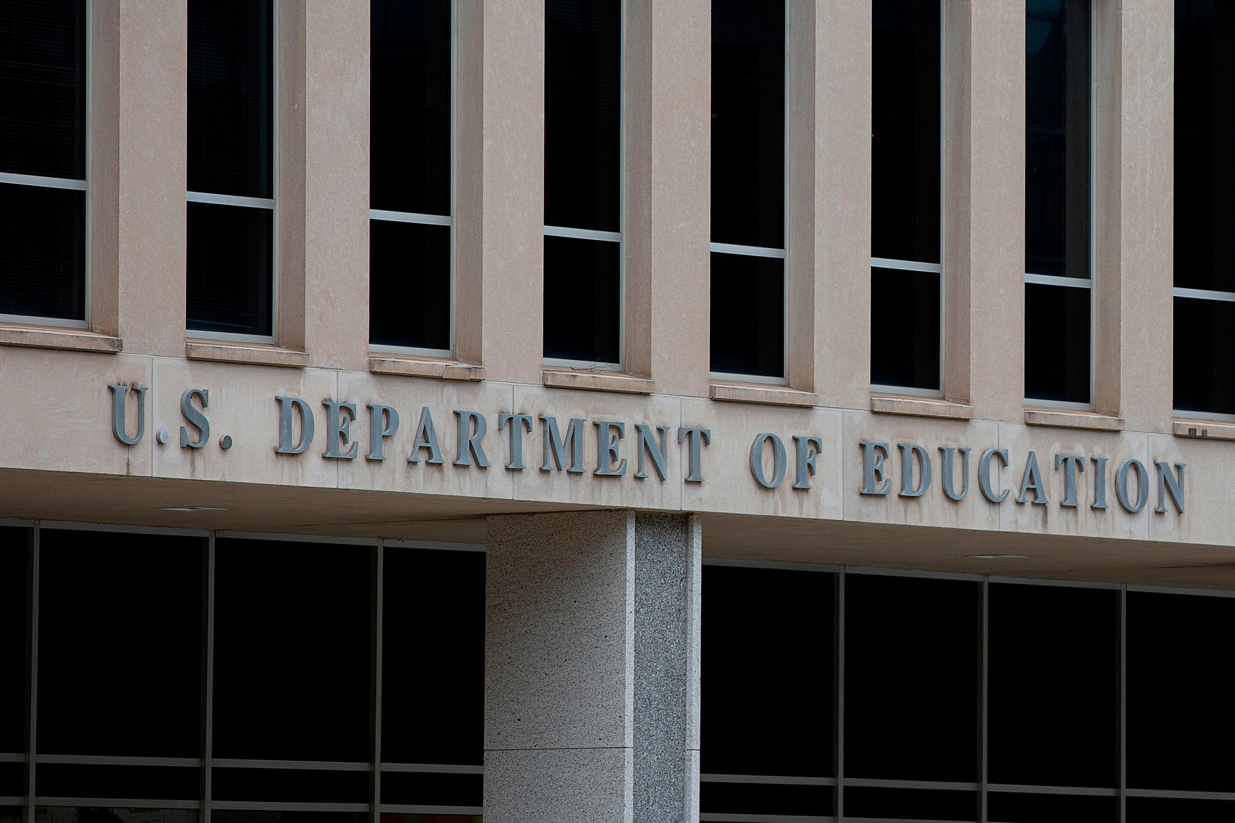 A building with the words “U.S. Department of Education” in gray letters on it.