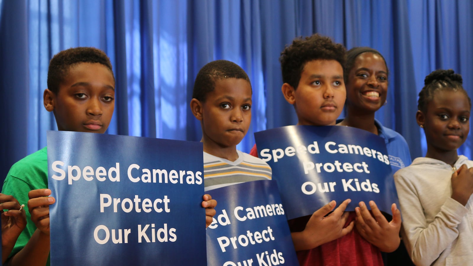 Students held signs during a press conference at Staten Island's P.S. 78, where Mayor Bill de Blasio called on state lawmakers to extend the city's speed camera program.