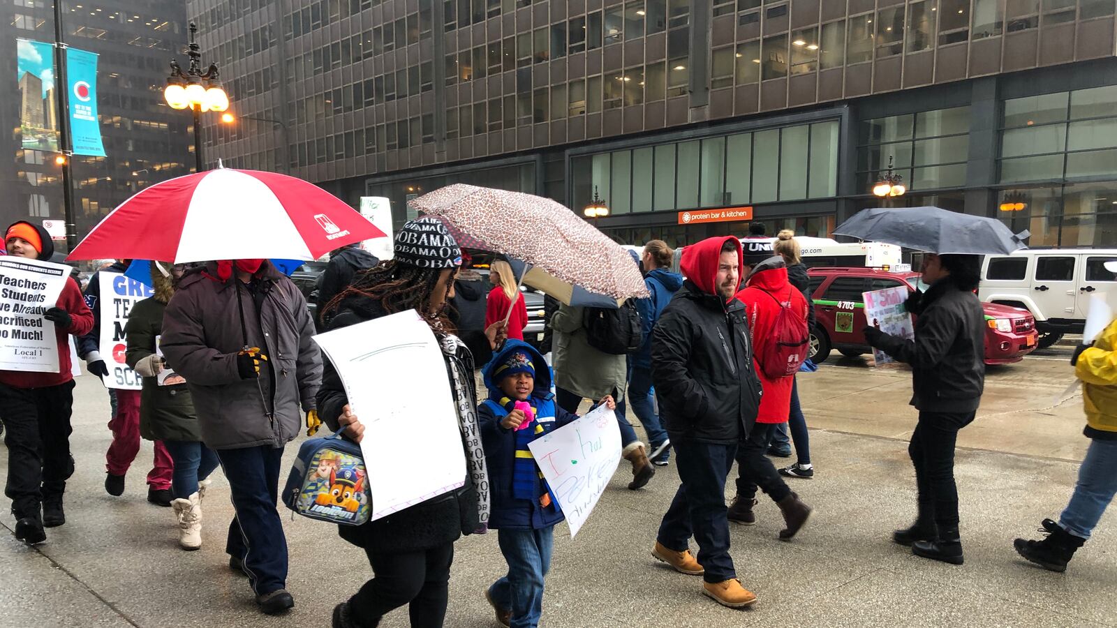 Lakeisha Poole and her son Isaiah, a first grader at CICS Wrightwood, march at a rally supporting striking CICS teachers.