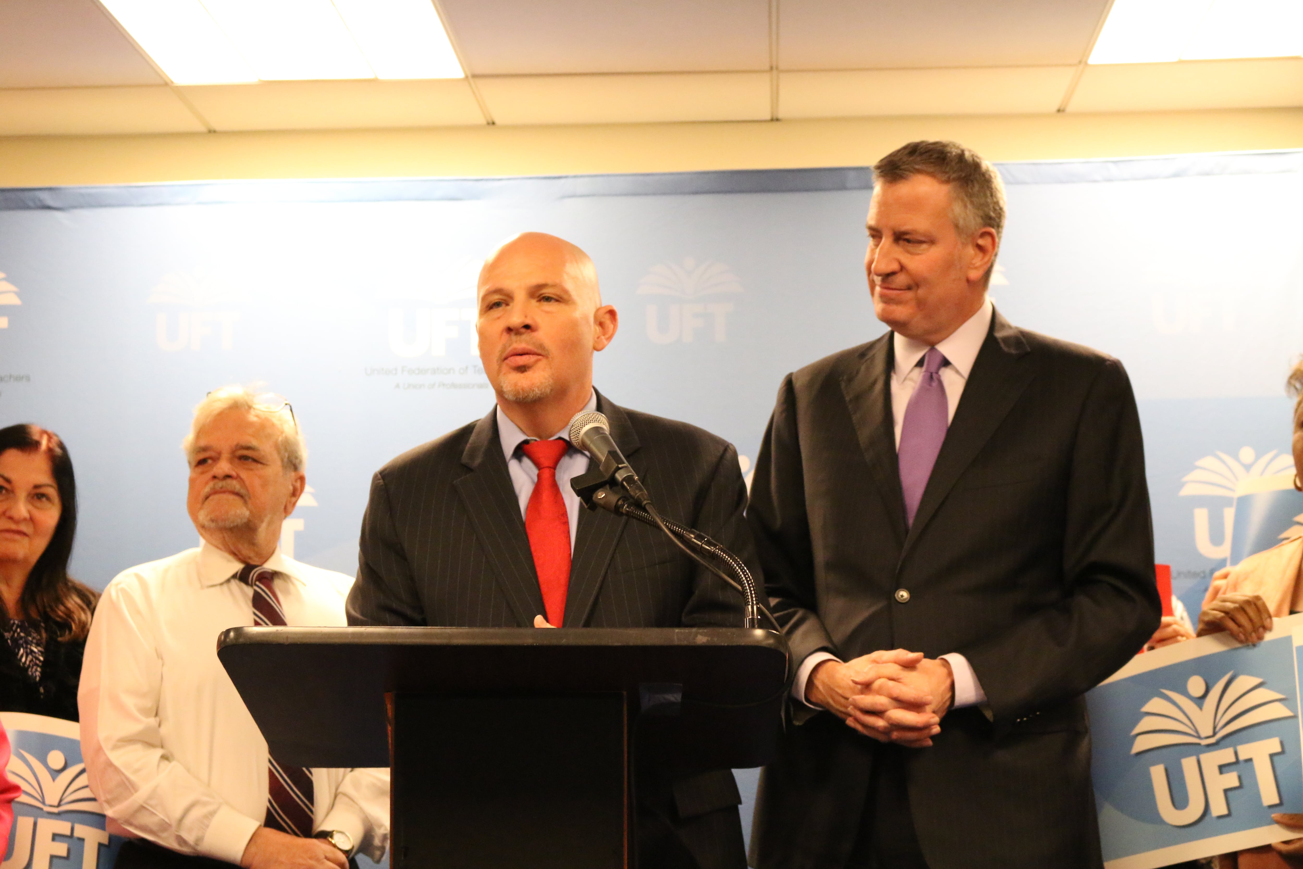 United Federation of Teachers President Michael Mulgrew, center, and Mayor Bill de Blasio
