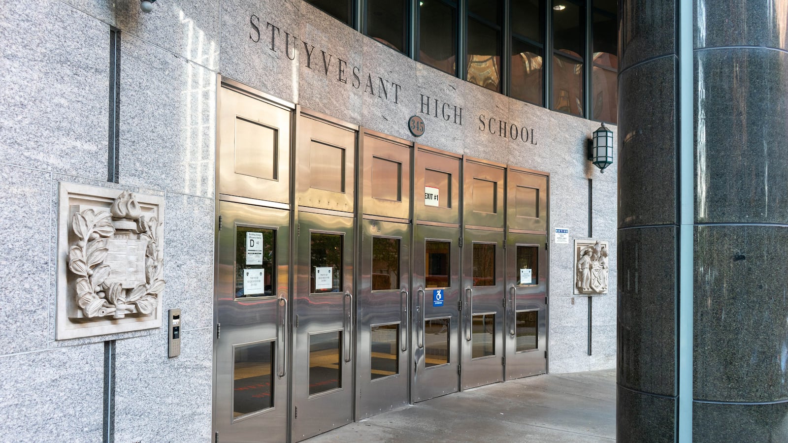 The entrance to a school building with giant words on the top that reads "Stuyvesant High School."