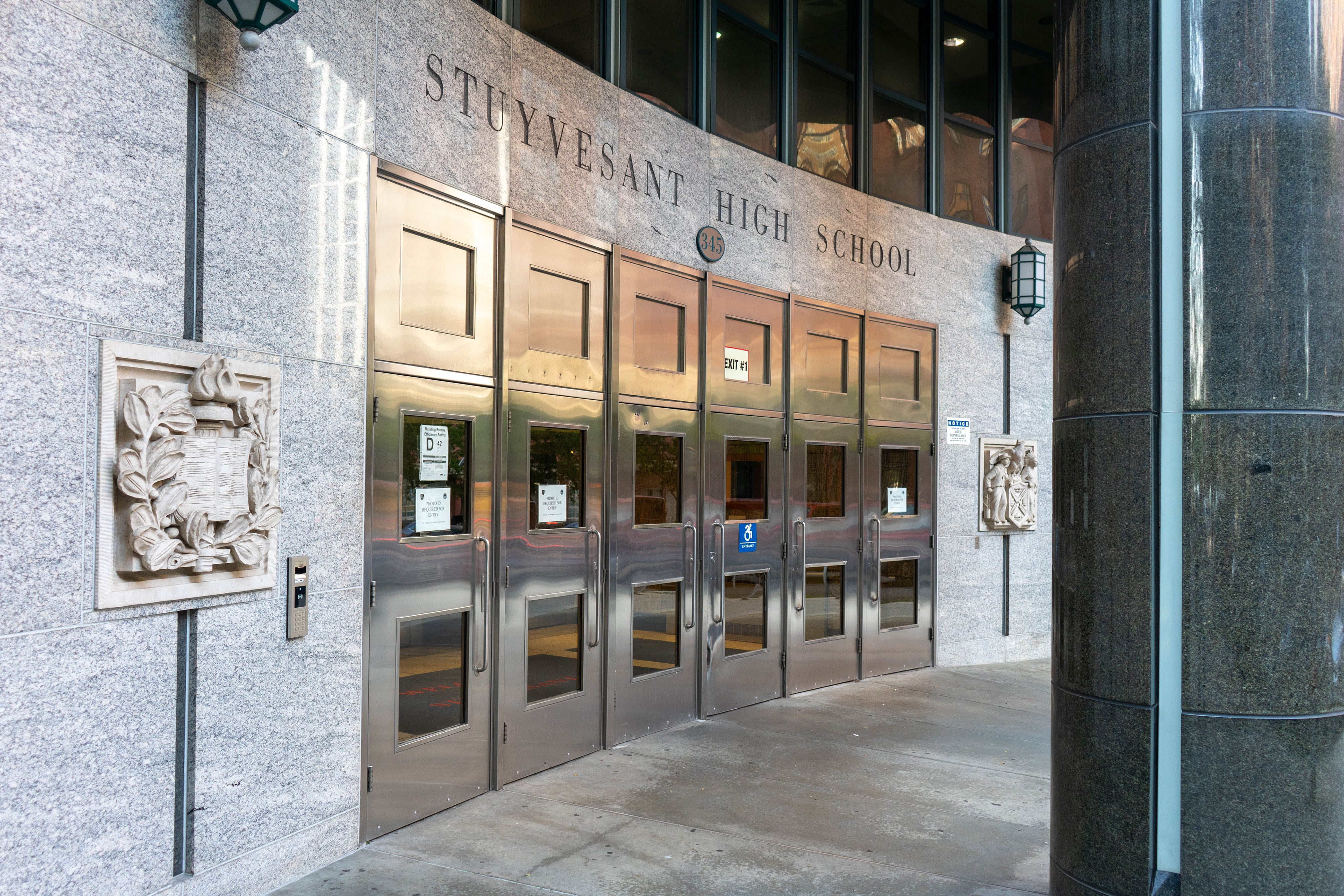 The entrance to a school building with giant words on the top that reads "Stuyvesant High School."