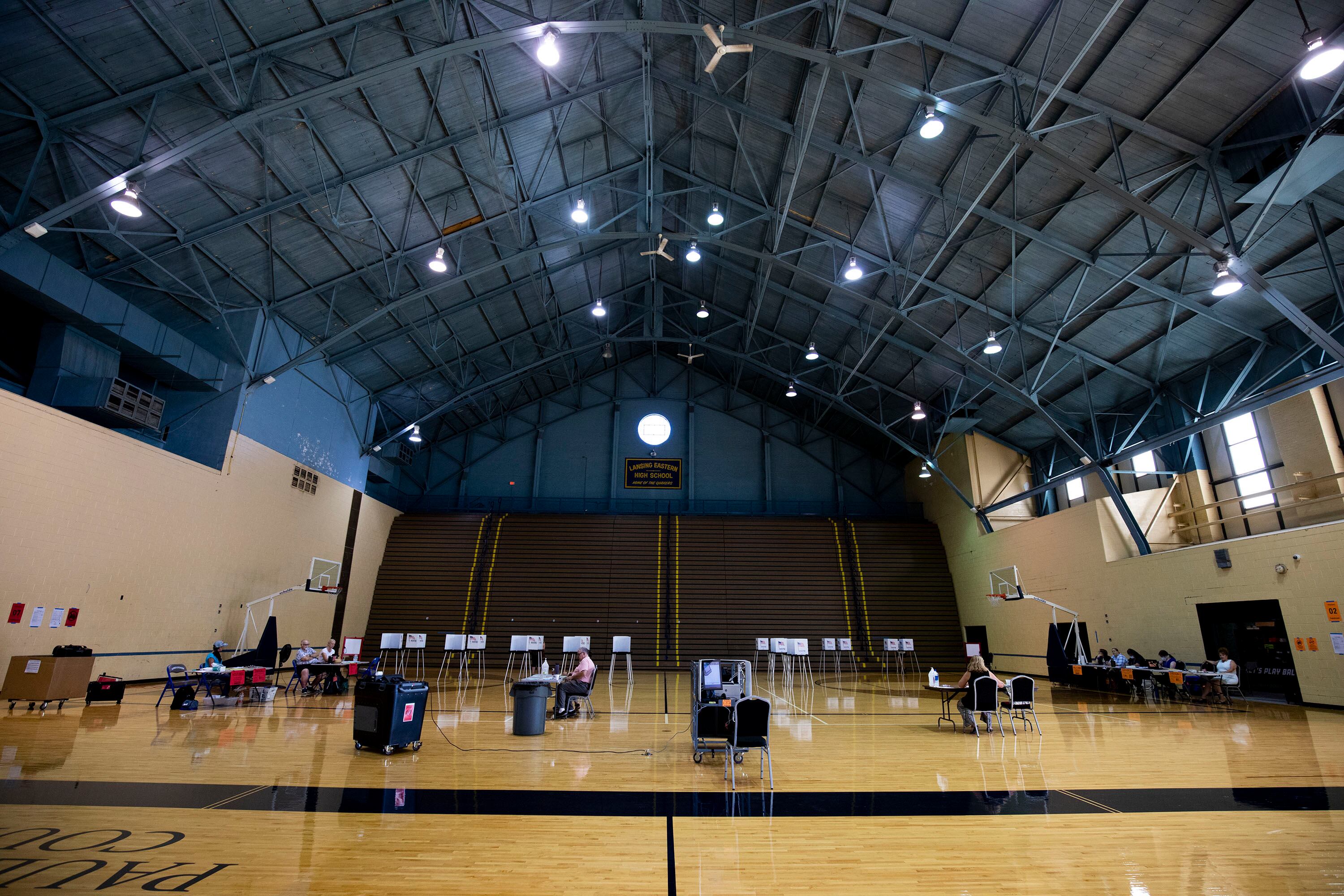 A high school gymnasium with voting polls.
