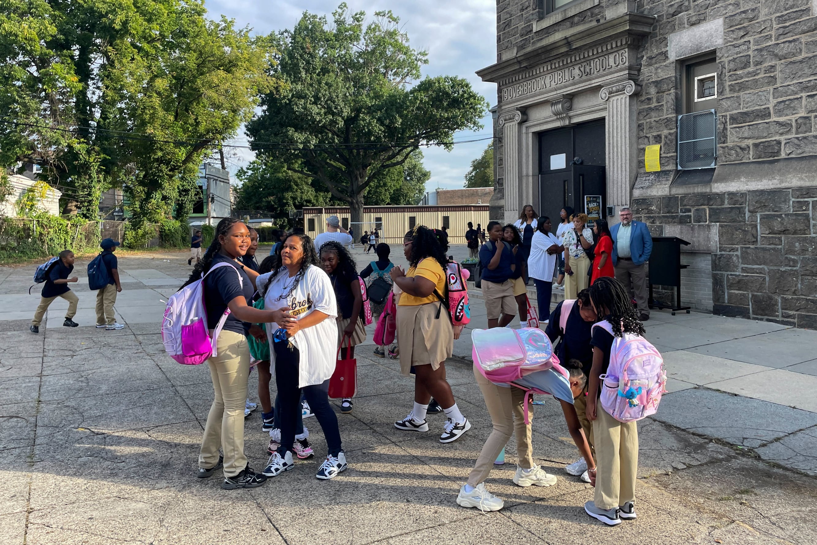 Students gathering in front of the school building