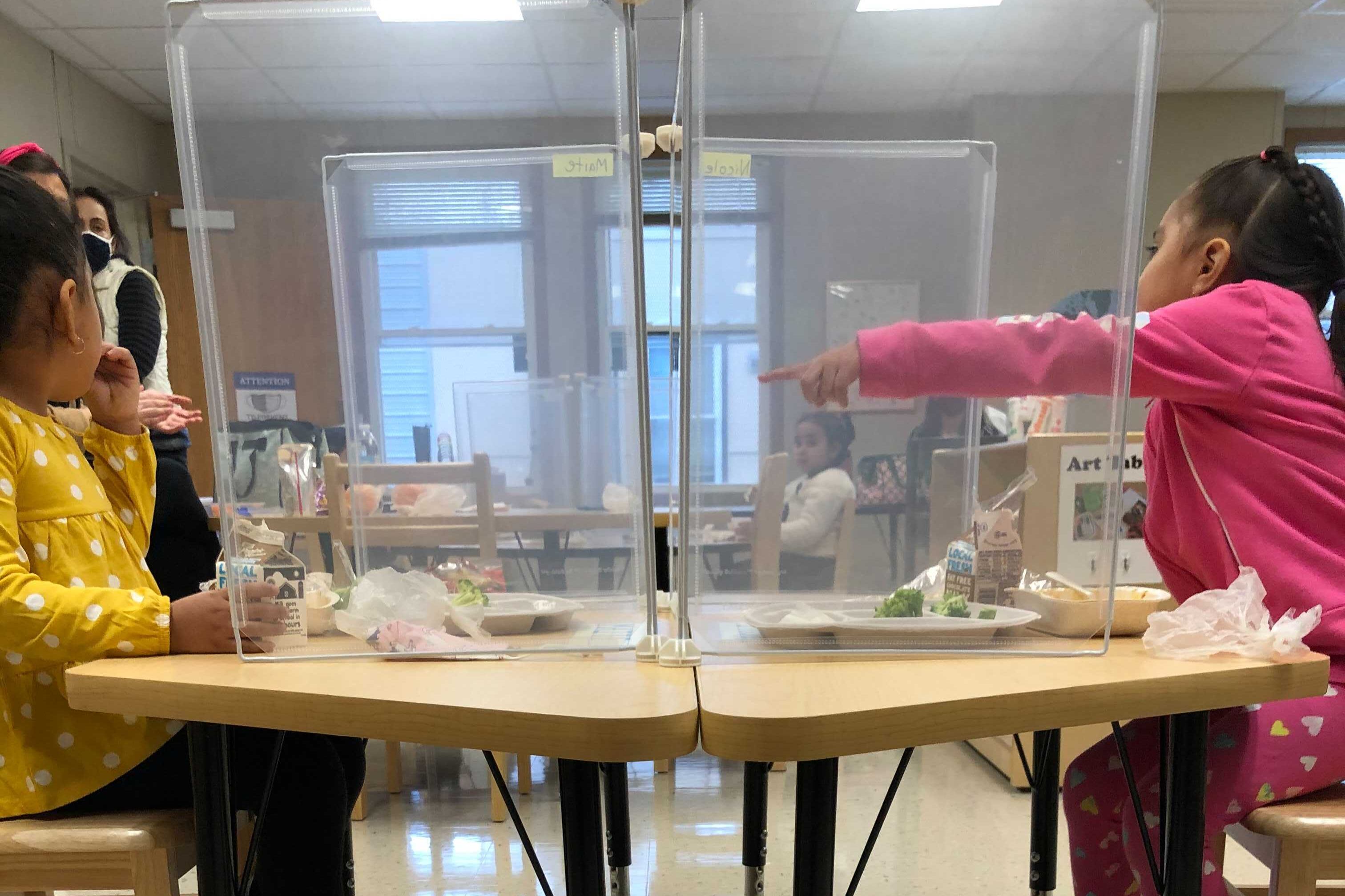 Pre-kindergarten students eat lunch at their desks under new COVID-19 rules in Chicago schools.
