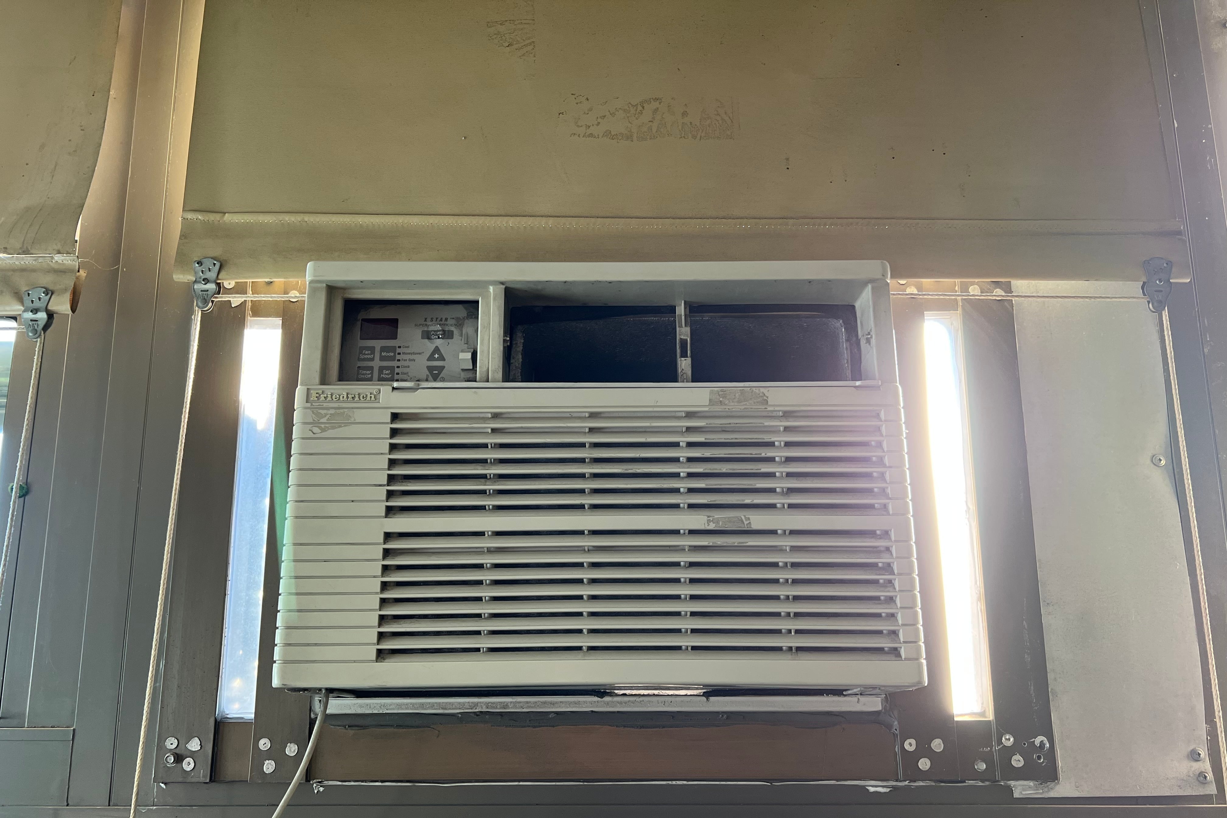 A close up of a wall air conditioning unit.