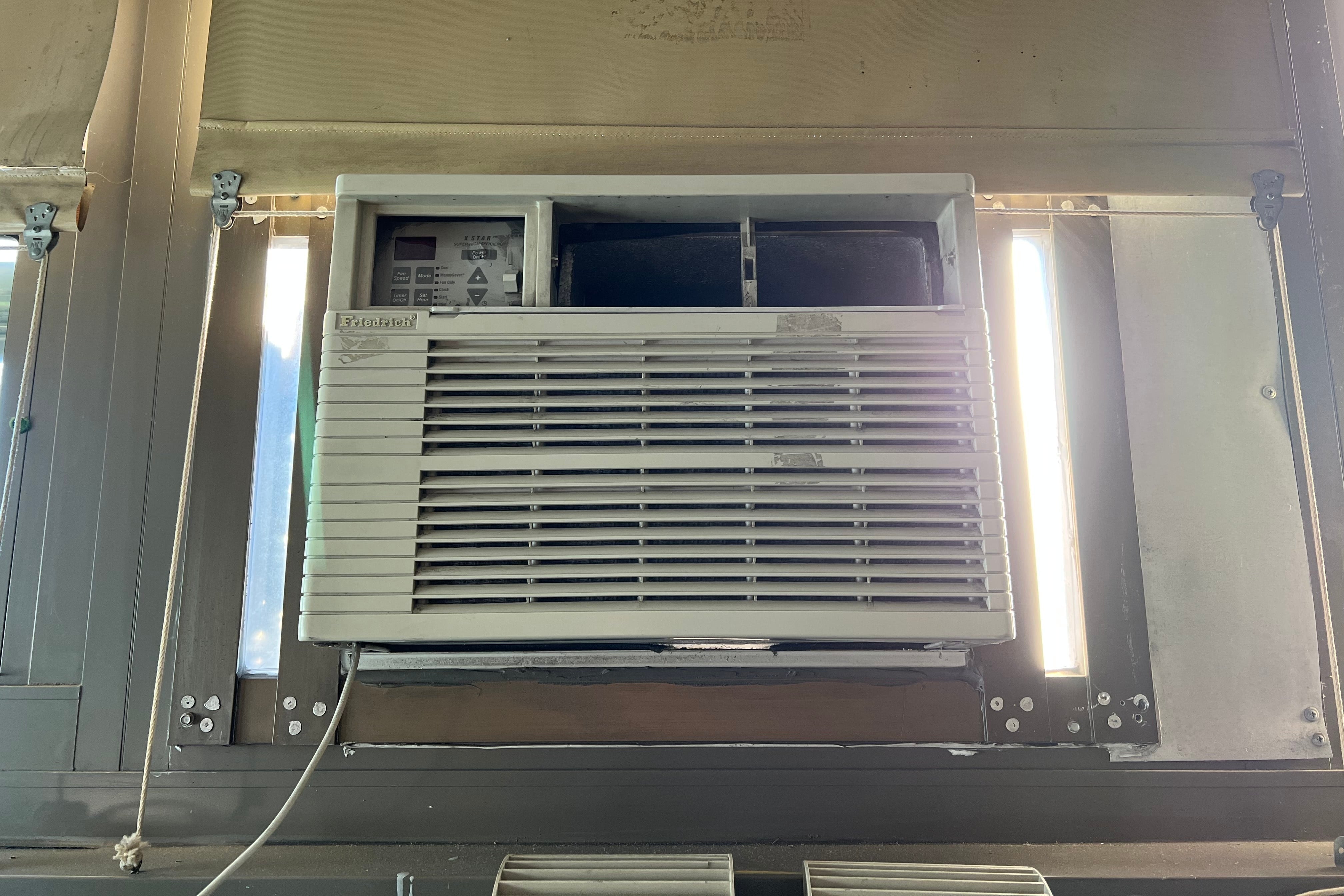 A close up of a wall air conditioning unit.