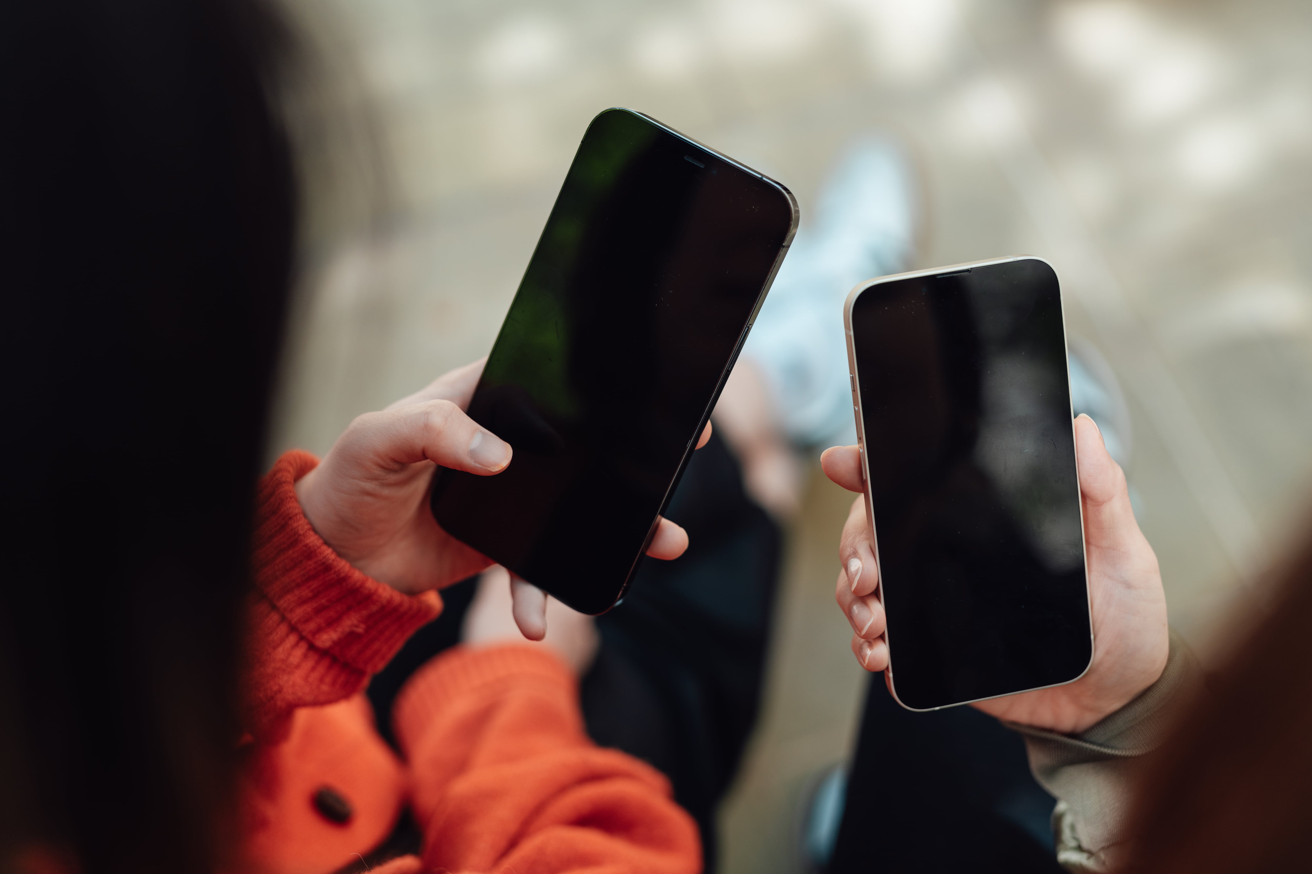 Hands hold cell phones