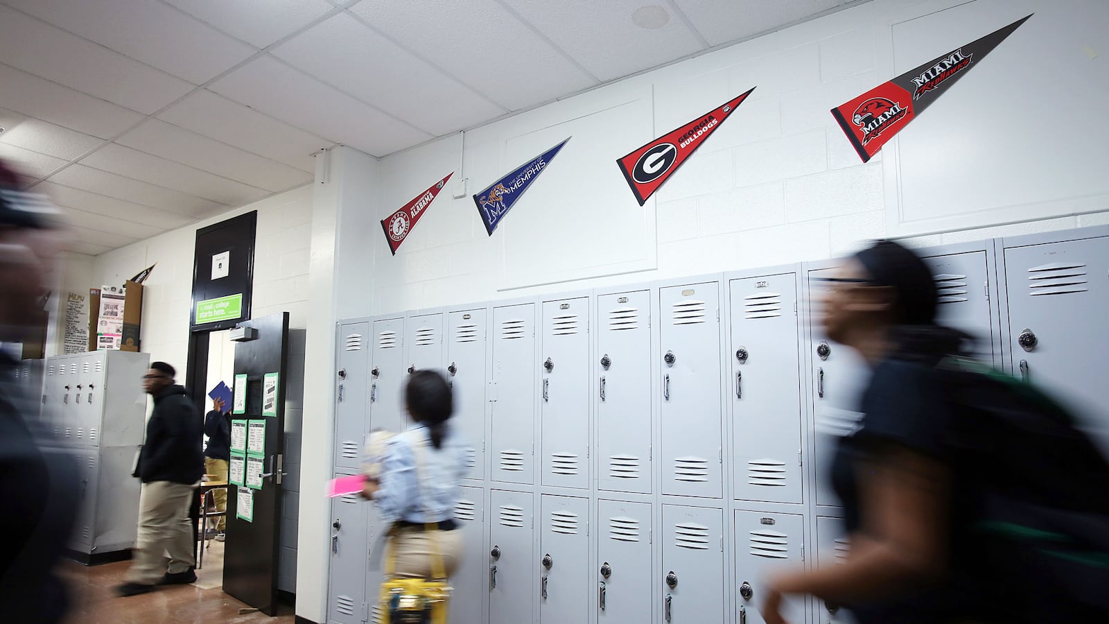 Students walk in a hallway past lockers at a Green Dot school in Memphis.