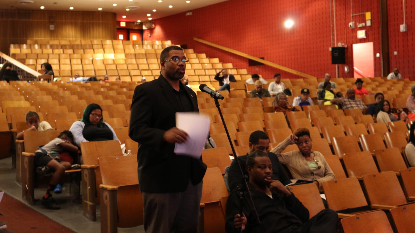 A community member speaks at public hearing at Brooklyn's Boys and Girls High School.