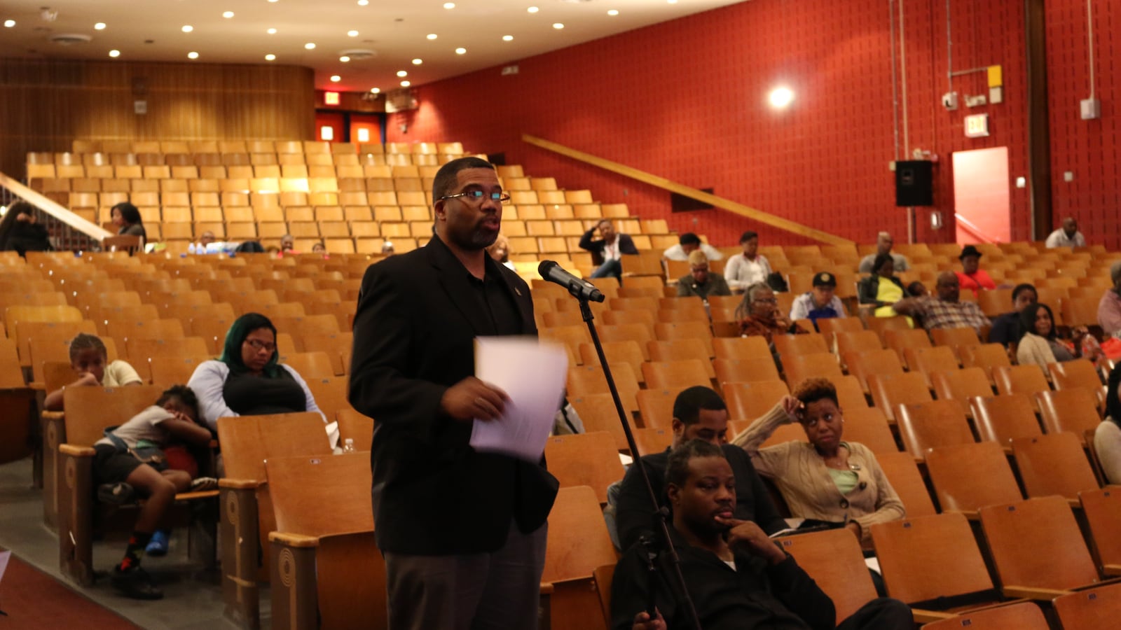 A community member speaks at public hearing at Brooklyn's Boys and Girls High School.