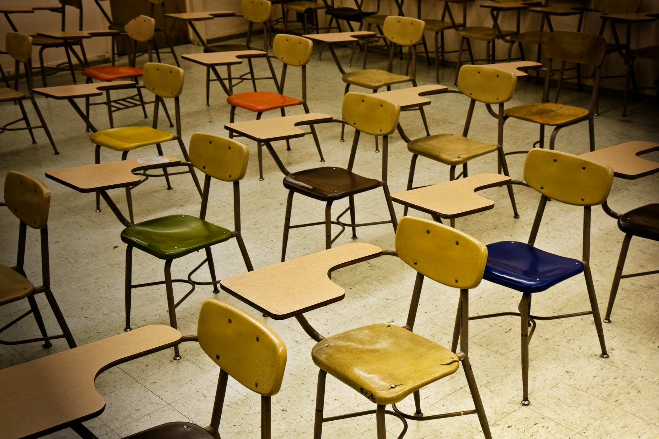 Colorful chairs in an empty classroom.