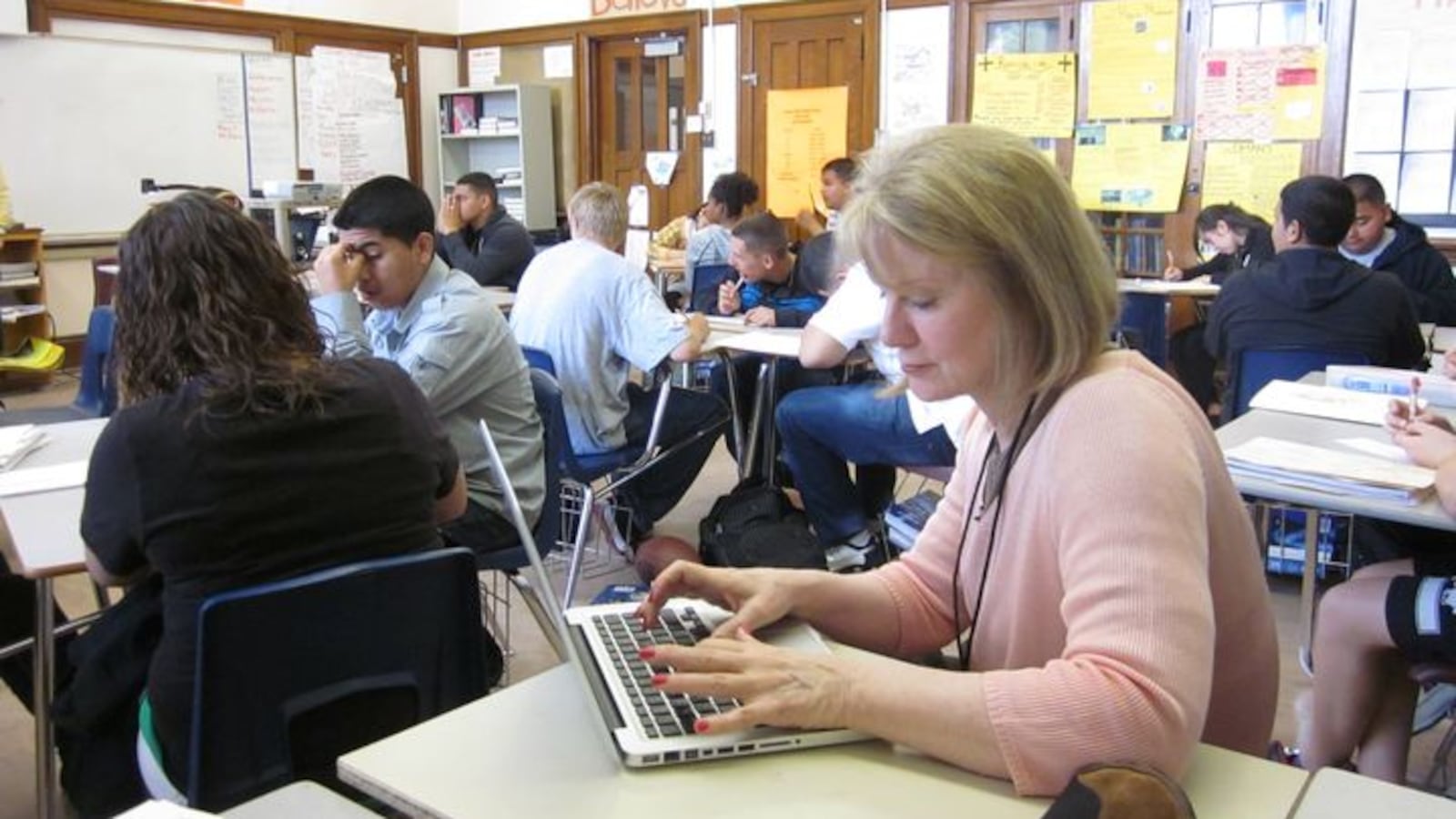 A DPS peer observer sitting in on a class at West High School in 2012.