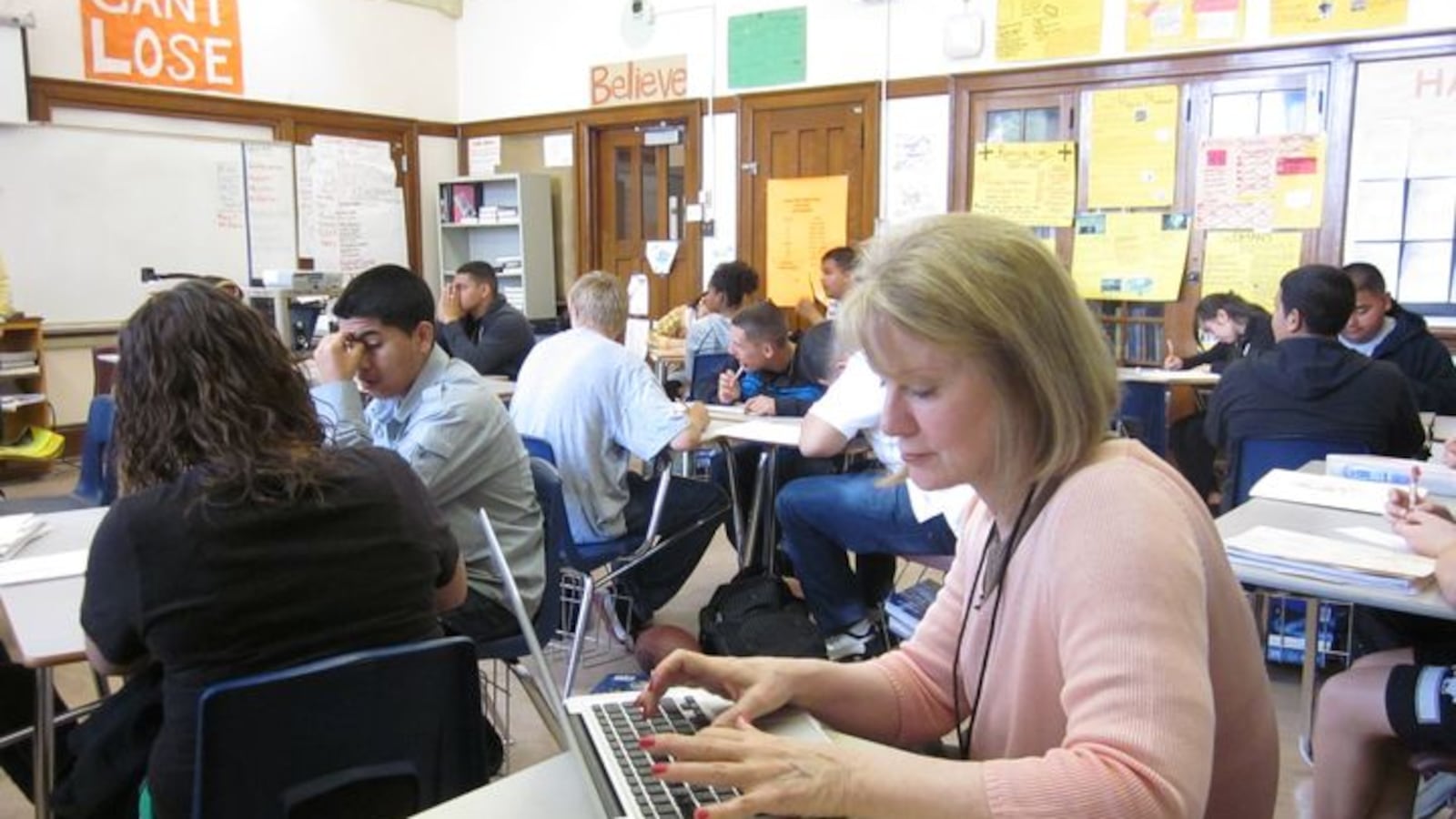 A DPS peer observer sitting in on a class at West High School in 2012.