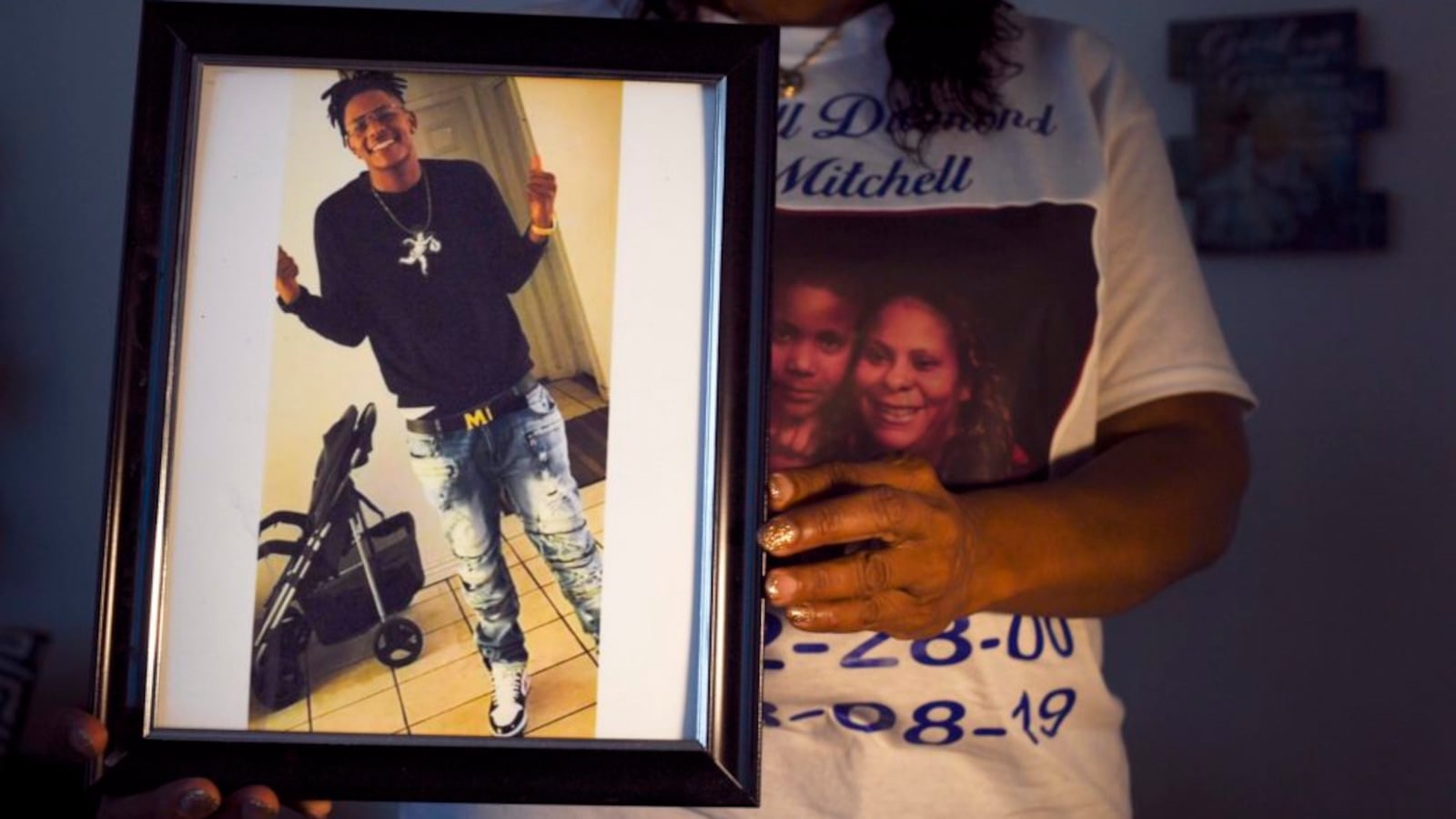 Metra Bell holds a photo of her 19-year-old son Darrell Mitchell, who was shot and killed in August 2019. The Denver school board observed a moment of silence at its January 2020 meeting for students lost to gun violence, including Mitchell.