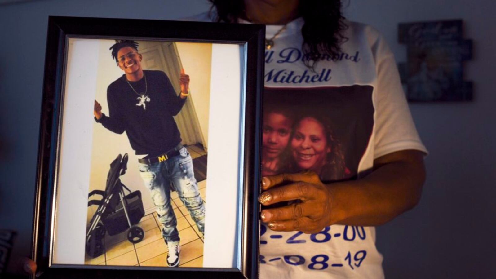 Metra Bell holds a photo of her 19-year-old son Darrell Mitchell, who was shot and killed in August 2019. The Denver school board observed a moment of silence at its January 2020 meeting for students lost to gun violence, including Mitchell.