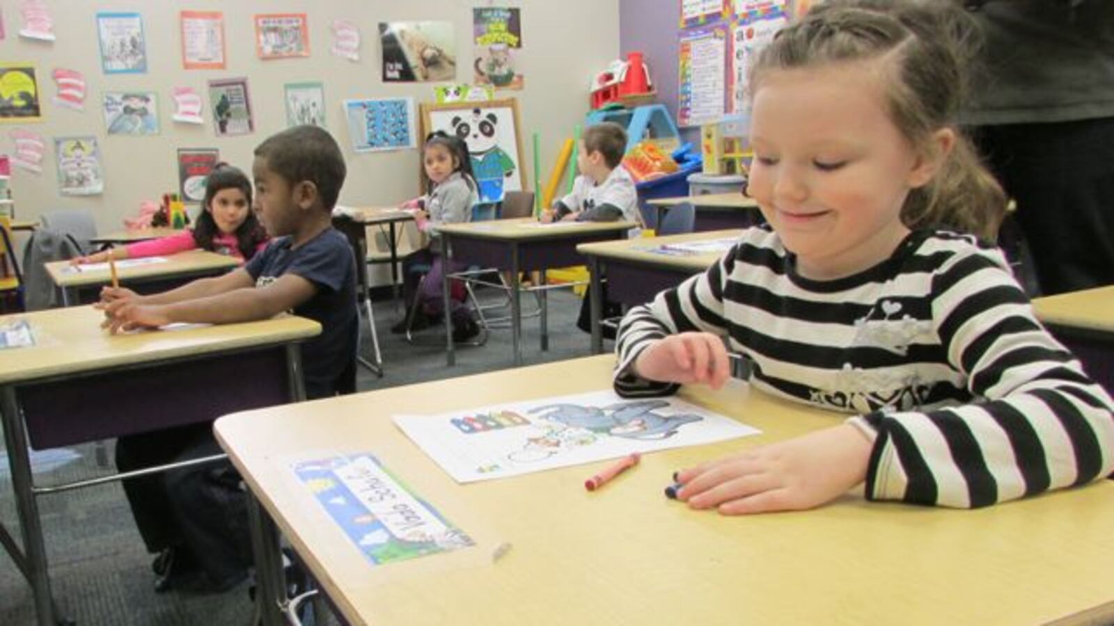 Vada Schafer, a student at Shepherd Community Center's preschool, is pleased with the clown she colored in during a visit by Gov. Mike Pence in 2014.
