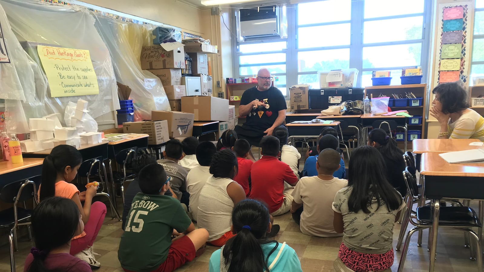 Students listen during a summer arts course designed for children learning English as a new language.