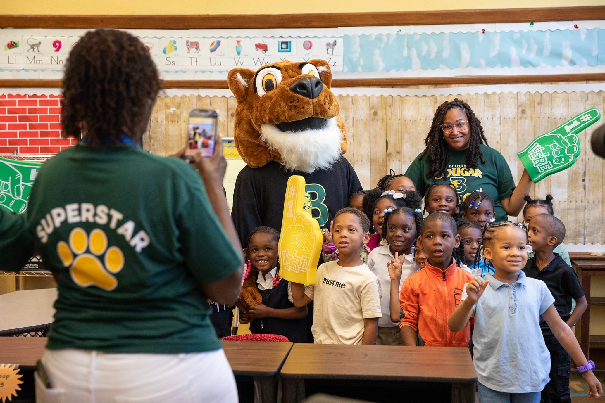 A group of students and staff pose for a photo on the first day of school in Detroit.