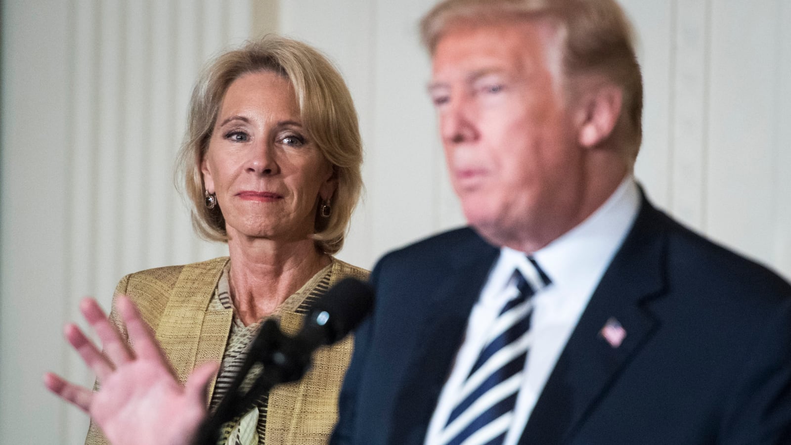 WASHINGTON, DC - MAY 2: Secretary of Education Betsy DeVos listens as President Donald J. Trump gives remarks at the National Teacher of the Year reception at the White House on May 02, 2018 in Washington, DC. (Photo by Jabin Botsford/The Washington Post via Getty Images)