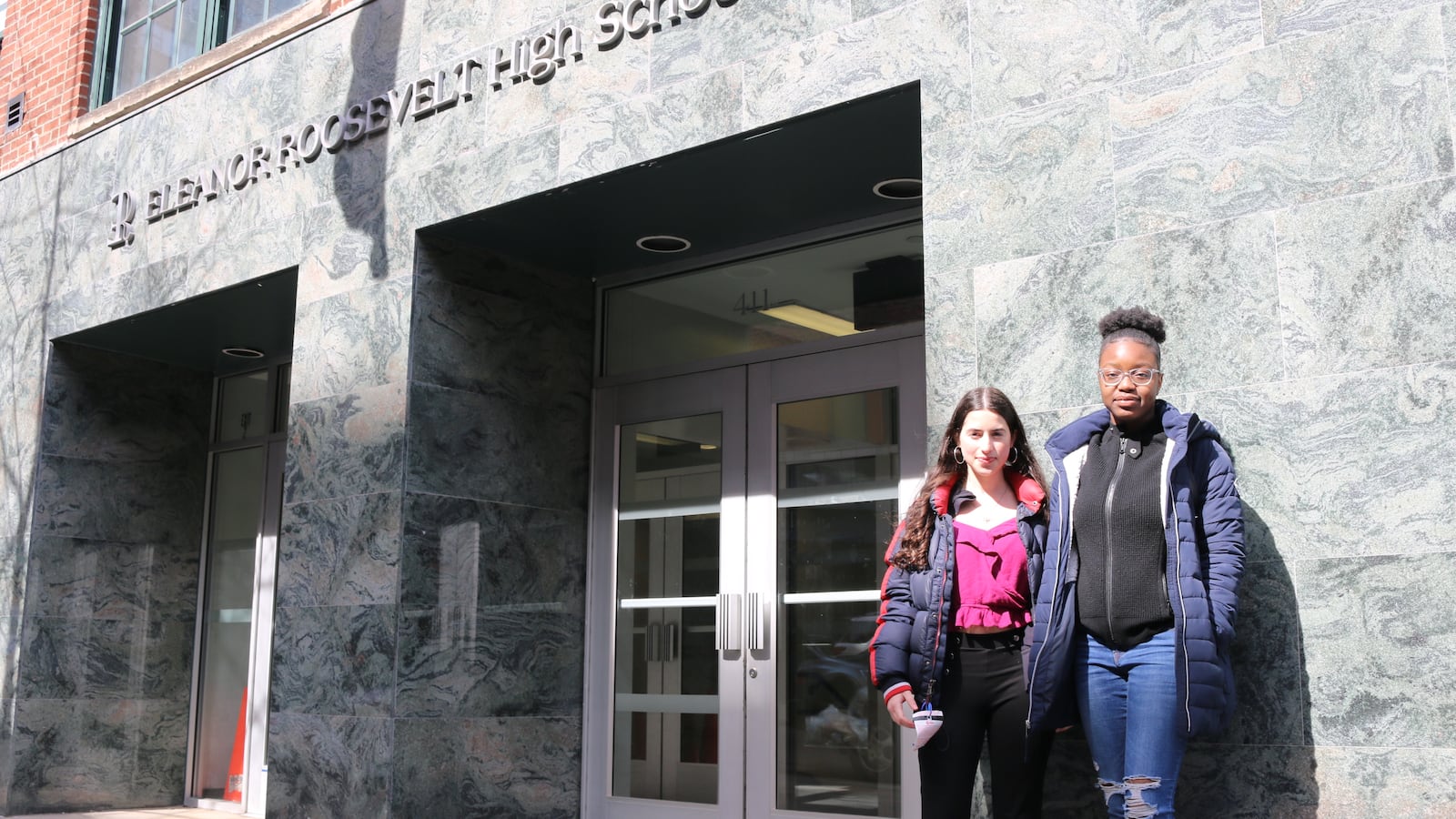 Students stand in front of Eleanor Roosevelt High School, which has one of the most rigorous academic screens for admission in the city.