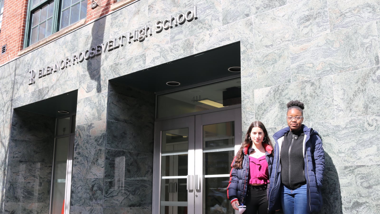 Students stand in front of Eleanor Roosevelt High School, which has one of the most rigorous academic screens for admission in the city.