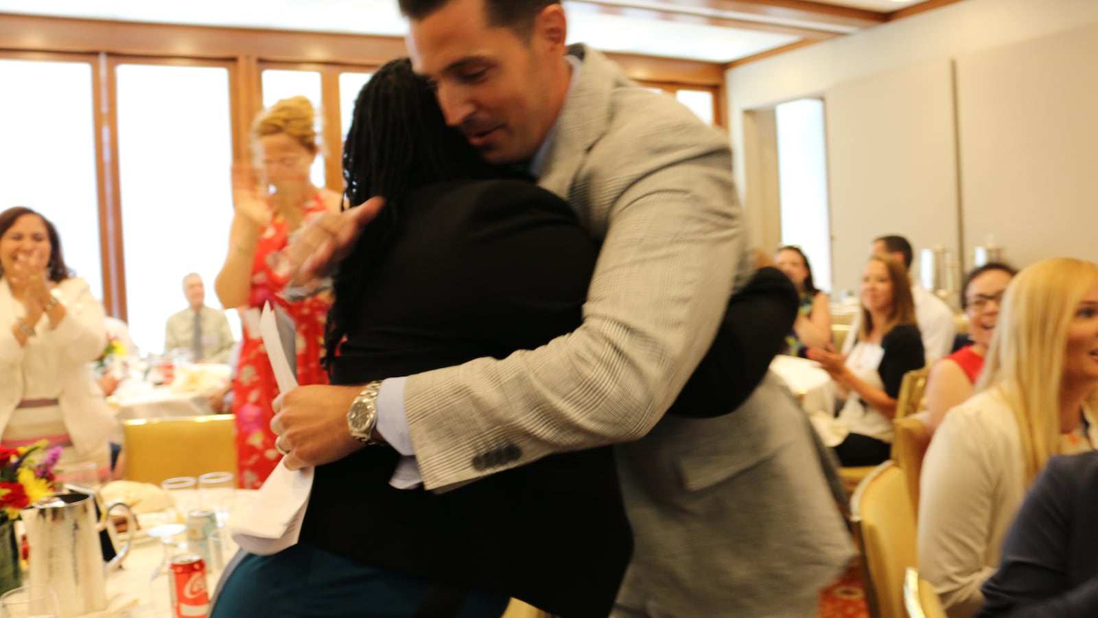 Vincent Gassetto, the principal M.S. 343, hugs a staff member after winning the Teaching Matters prize in July 2017.