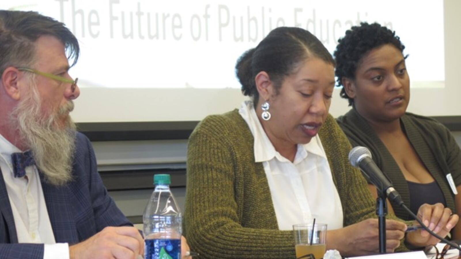 Teacher Geoff Davis (left) and Parent Power co-founder Delana Stardust Ivey (right) listen to Robin Hughes, executive associate dean of the Indiana University School of Education in Indianapolis.