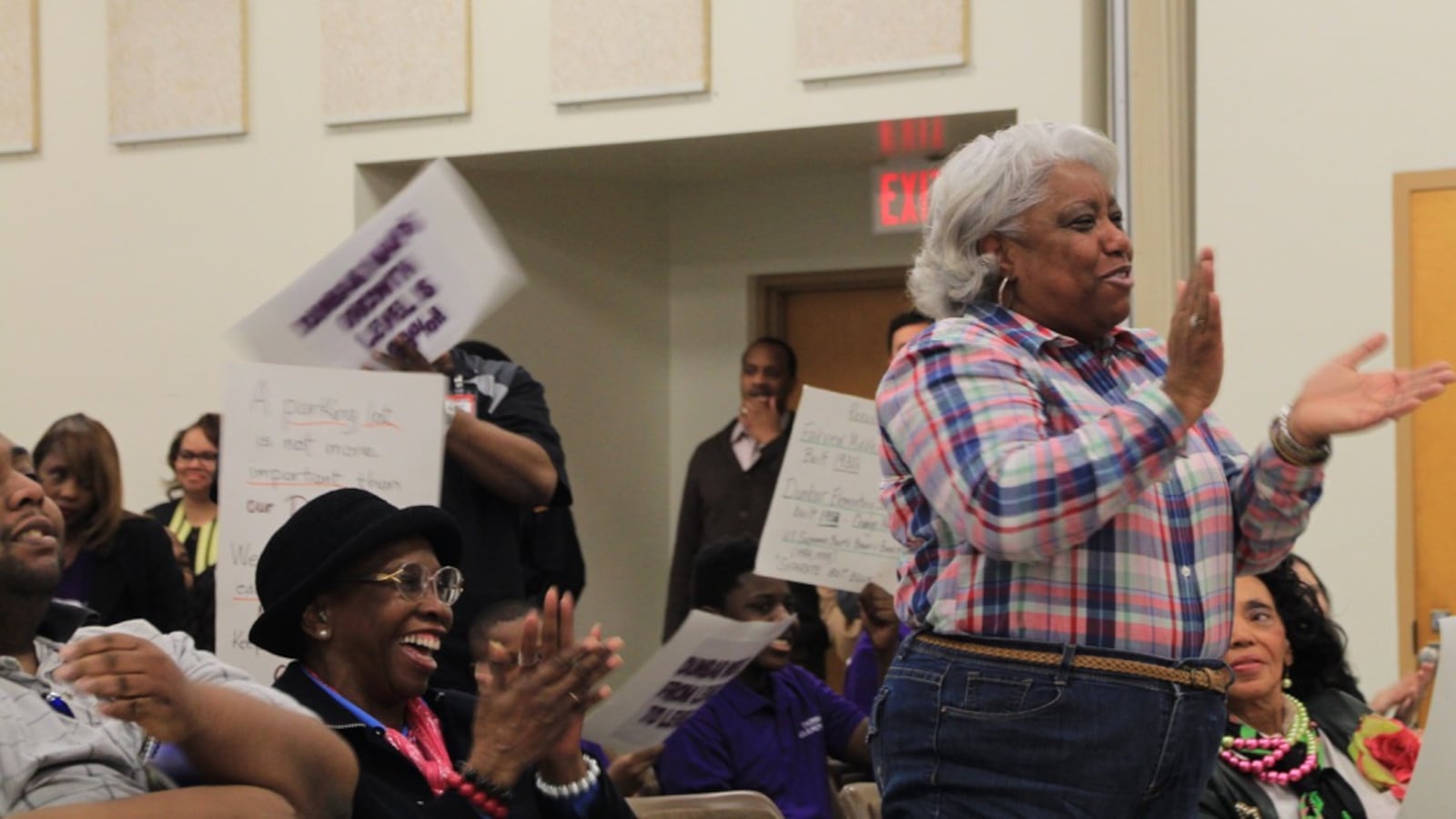 Claudette Boyd applauds during public comment at a Shelby County Schools board meeting regarding a vote to close Dunbar Elementary School.