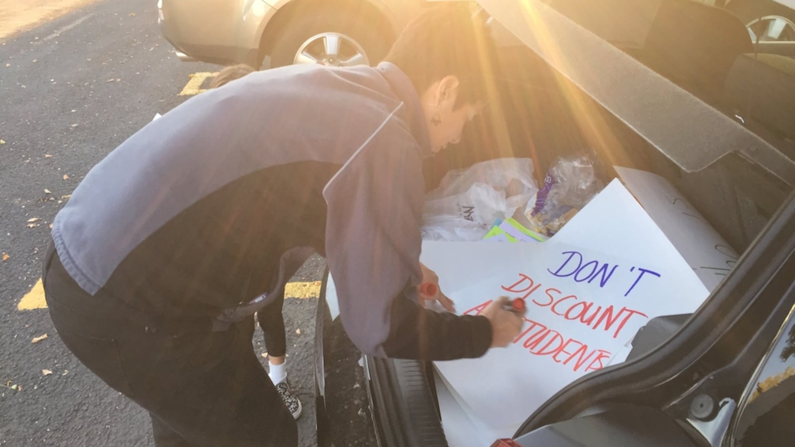 Leslie Aranjo a Jeffco parent and teacher prepares a protest sign Friday morning. A small group of teachers and parents met at the corner of Kipling Street and Bowles Avenue to raise awareness of their concerns about the school district's board majority.