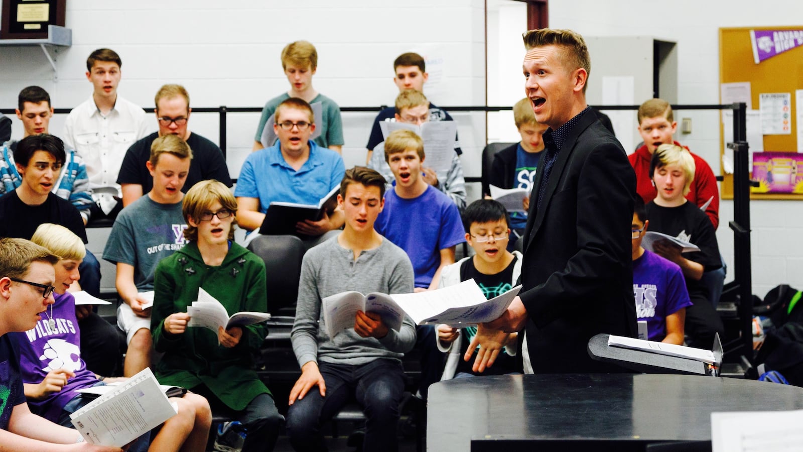 Chris Maunu, choir director at Arvada West High School, works with students.