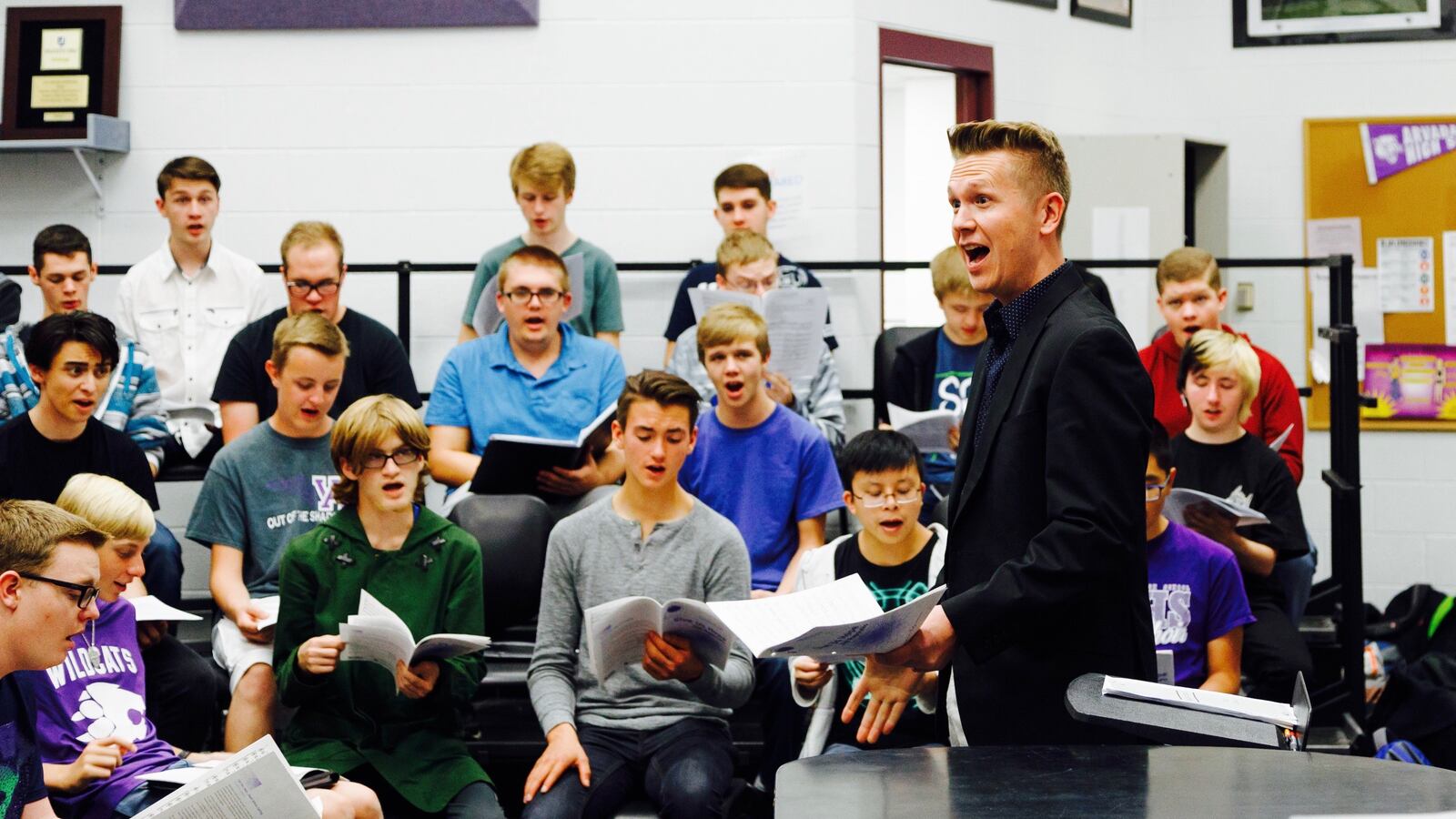 Chris Maunu, choir director at Arvada West High School, works with students.