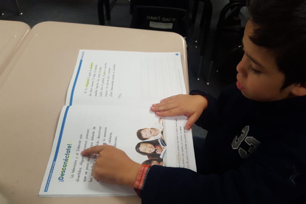 A first-grade student reads in Spanish in a biliteracy classroom at Dupont Elementary in Adams 14.