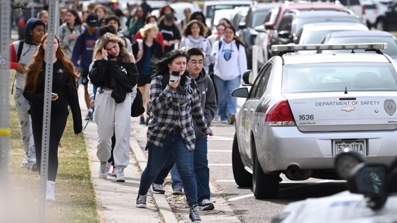 Students leave Denver’s East High School after a shooting there on Wednesday, March 22, 2023.