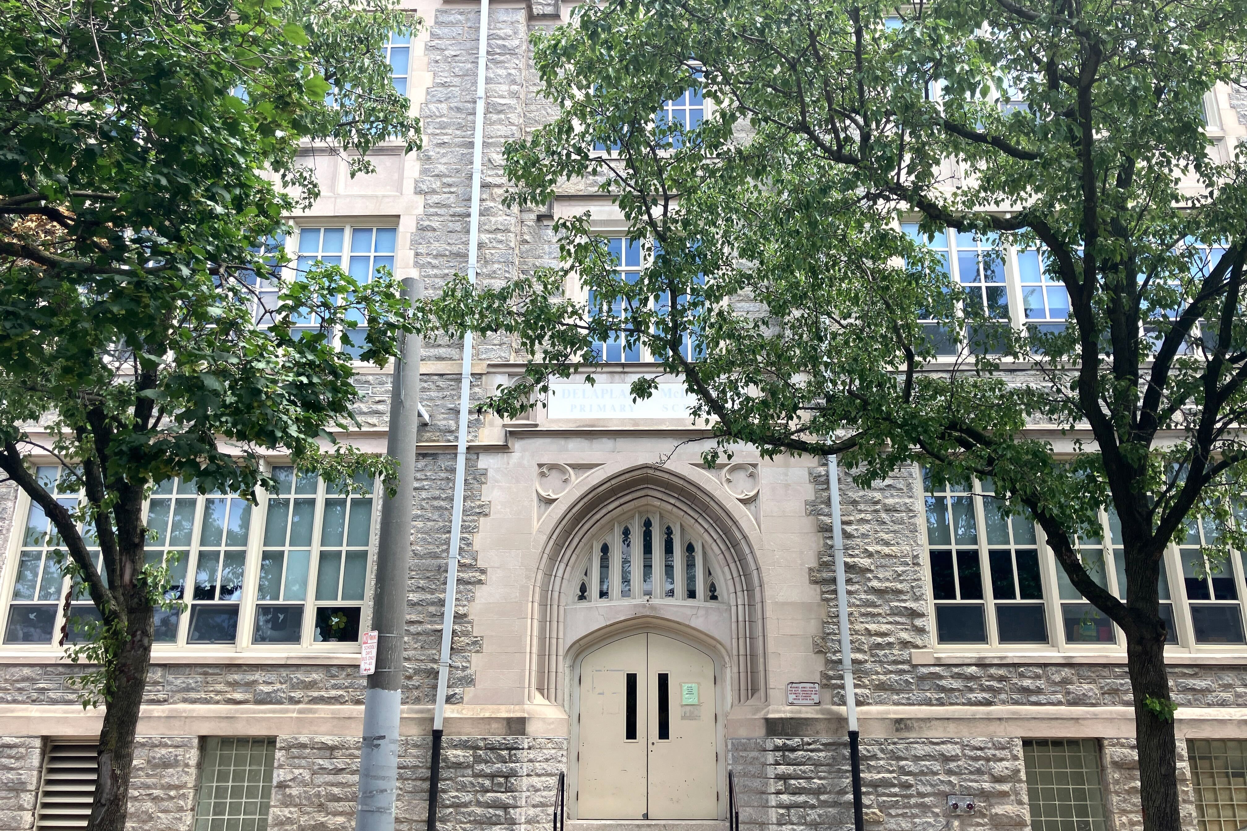 A brick building with an arched doorway.