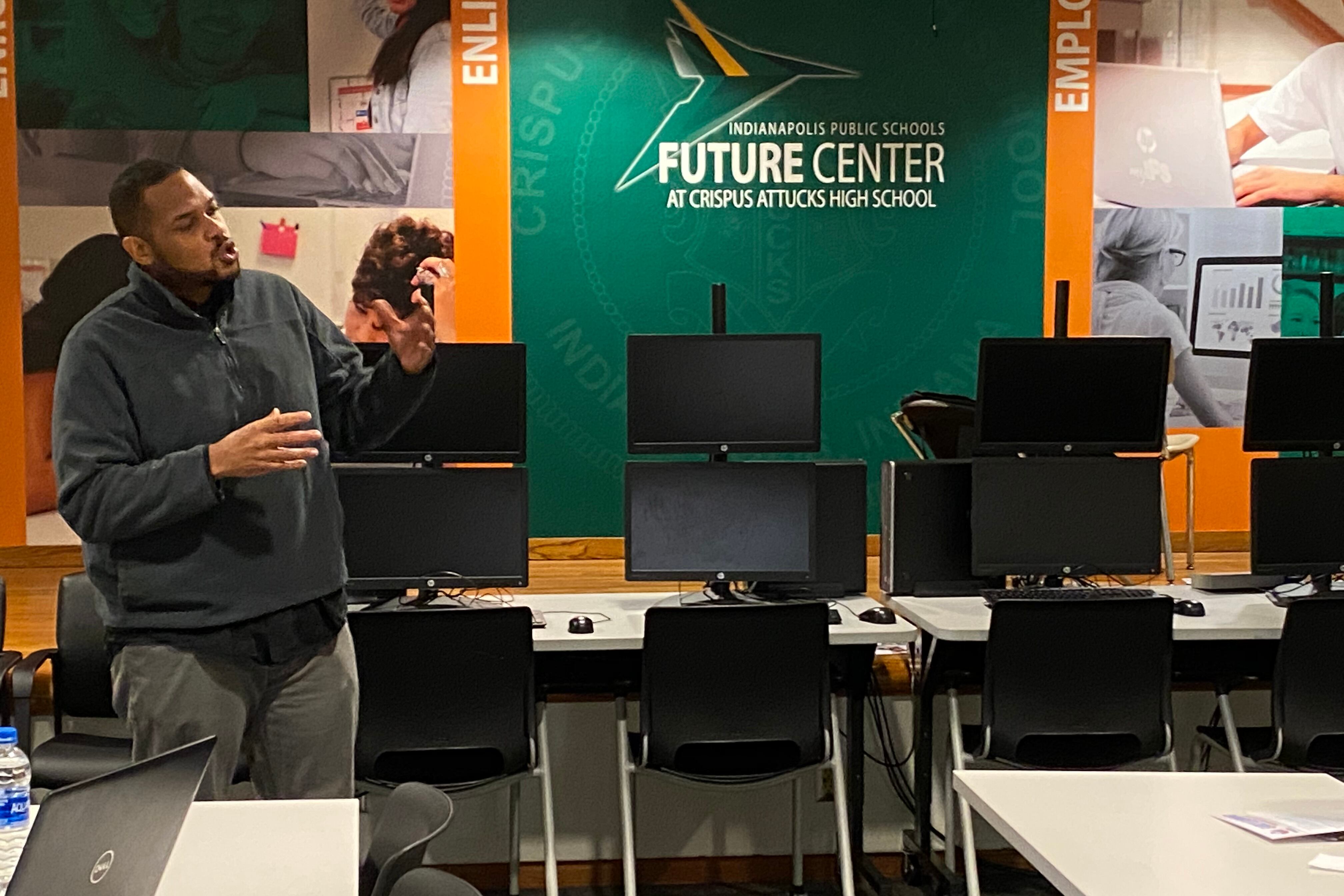 Early Learning Director Kahlil Mwaafrika gives a presentation at Crispus Attucks High School.
