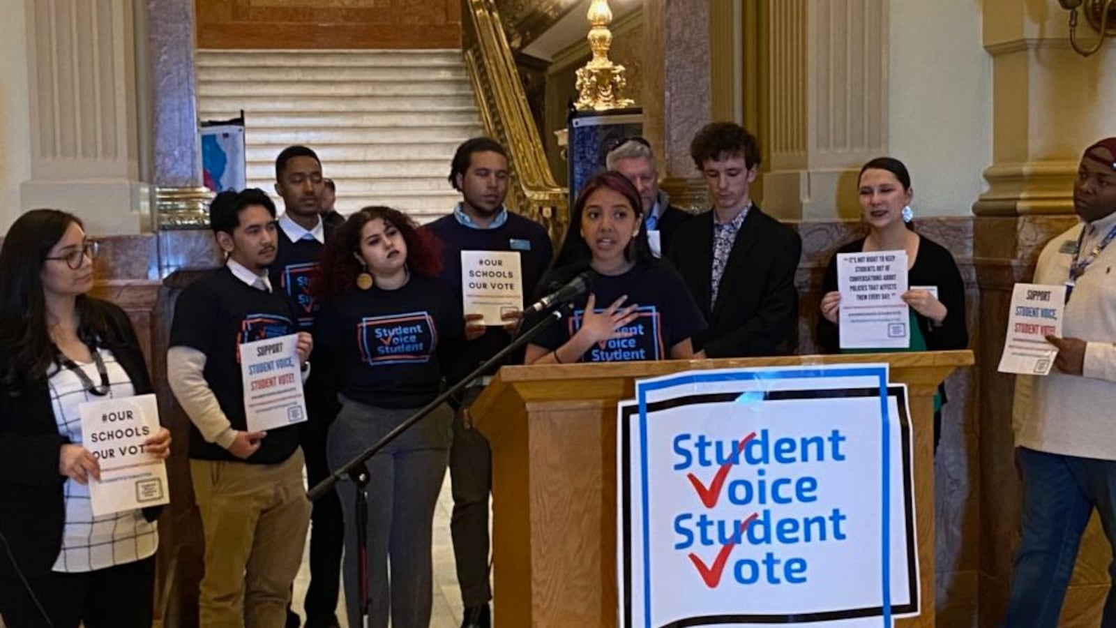 Kayla Morrison, a sophomore at Denver's South High School, speaks in support of 16-year-olds voting in school board elections, surrounded by supporters, including state Rep. Serena Gonzales-Gutierrez (far left) and Denver school board member Tay Anderson (far right).