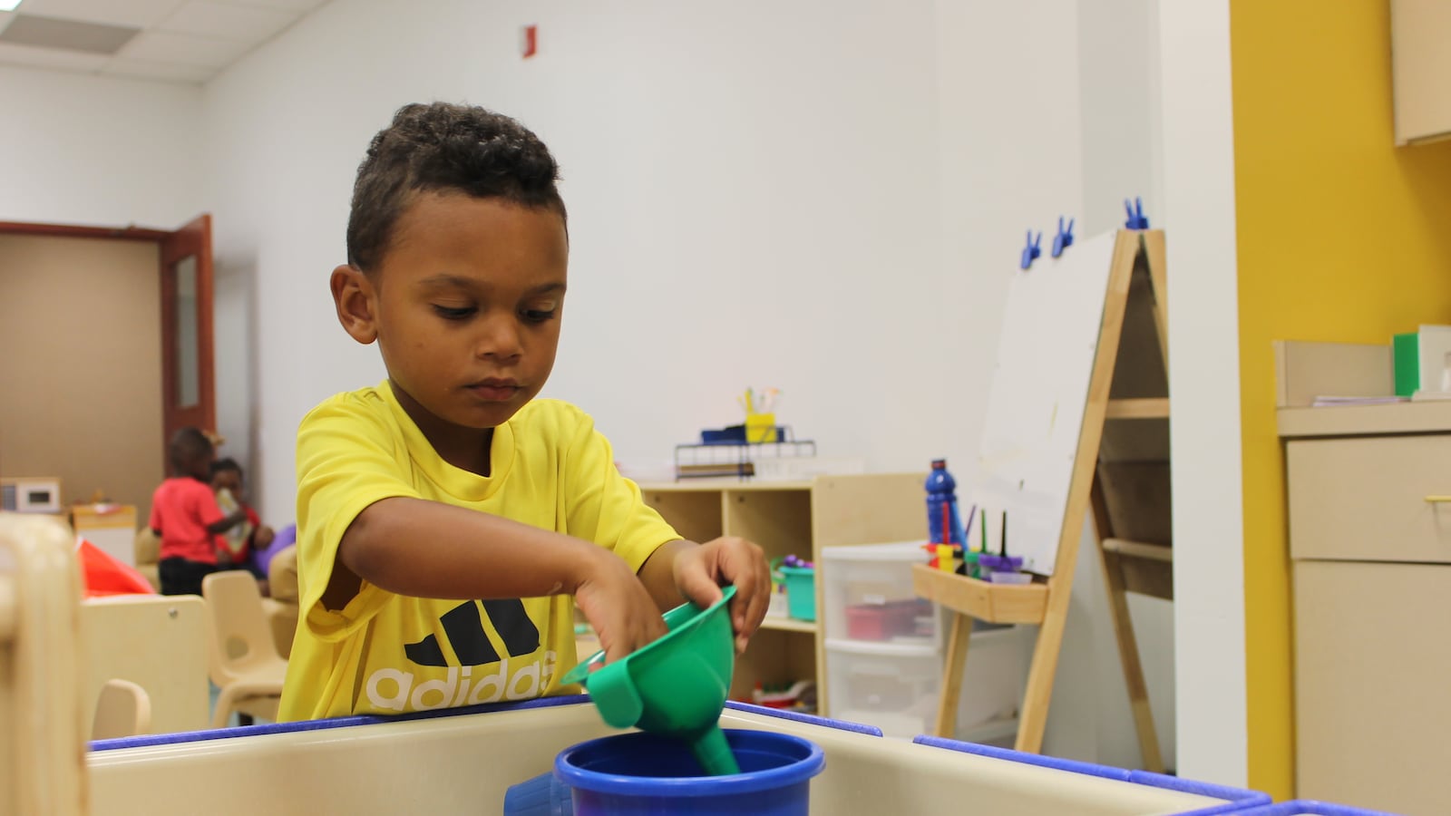 Three-year-old Ra'Jon Whitaker plays at a sensory center in his preschool classroom at Day Early Learning at Eastern Star Church.