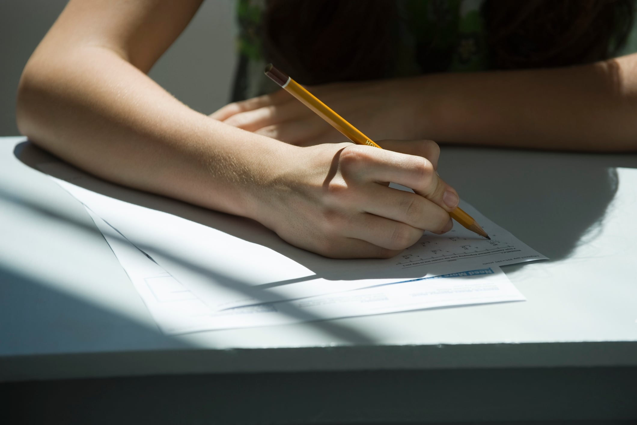A student answers a question on a test using a pencil.