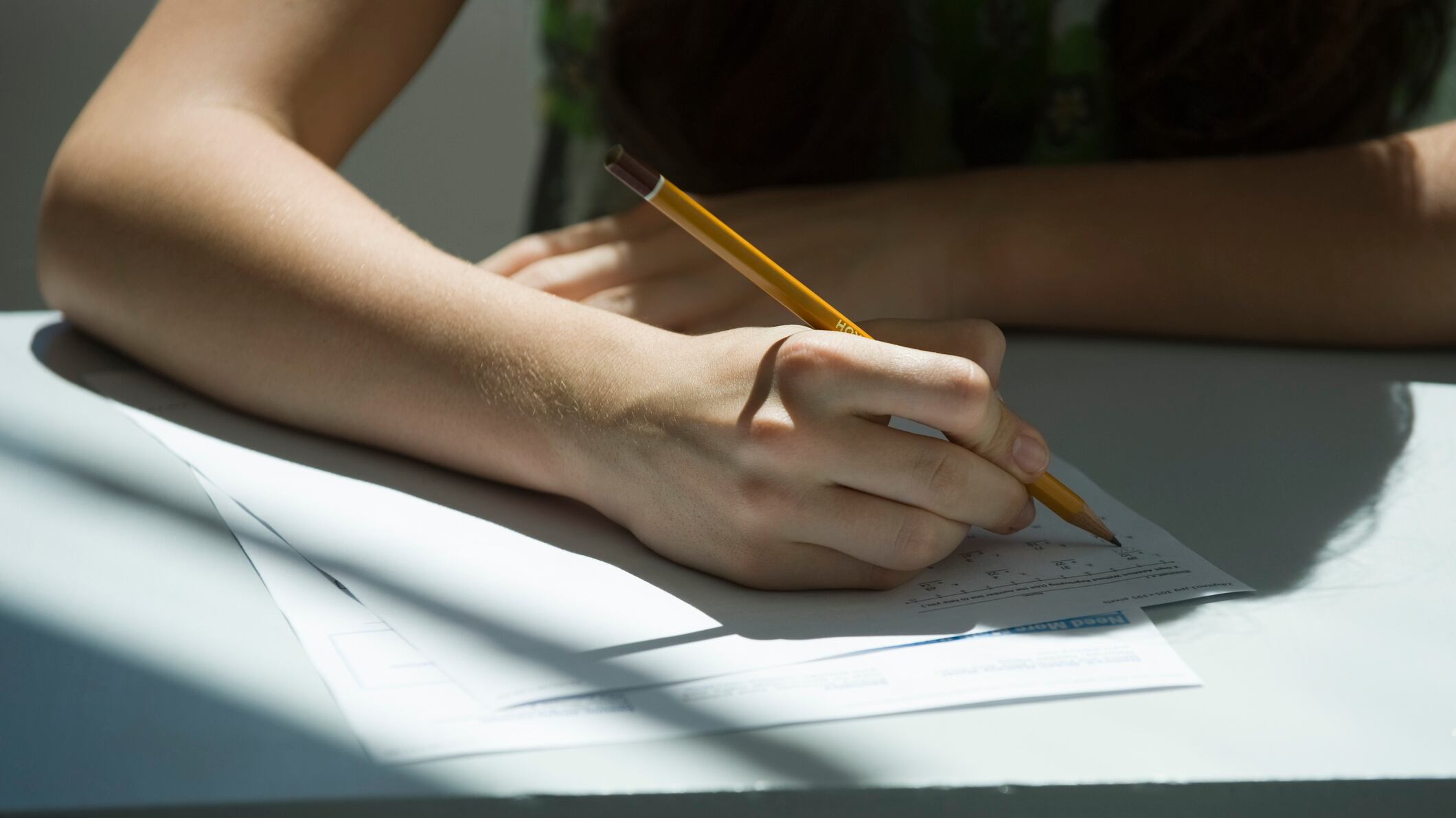 A student answers a question on a test using a pencil.