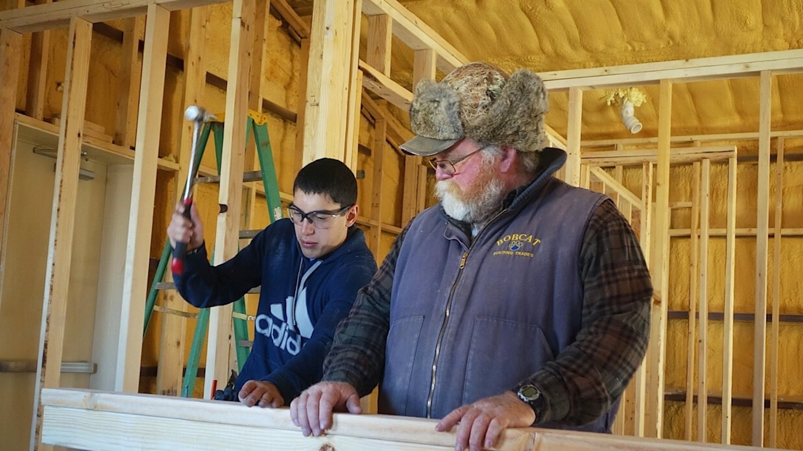 Ray Perez, a sophomore at Custer County High School, works with instructor Bruce May on a project that will convert a former preschool building into teacher housing.