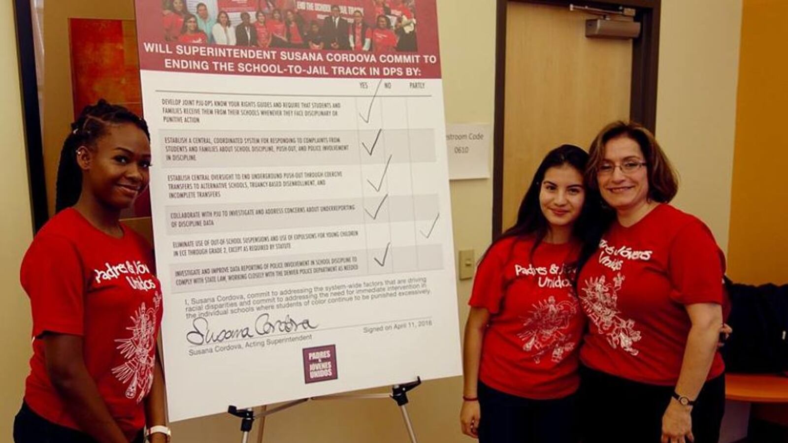 DPS acting superintendent Susana Cordova signed on to several proposed school discipline solutions Monday. Here, she poses with students Jaquikeyah Fields and Patricia Cardenas.