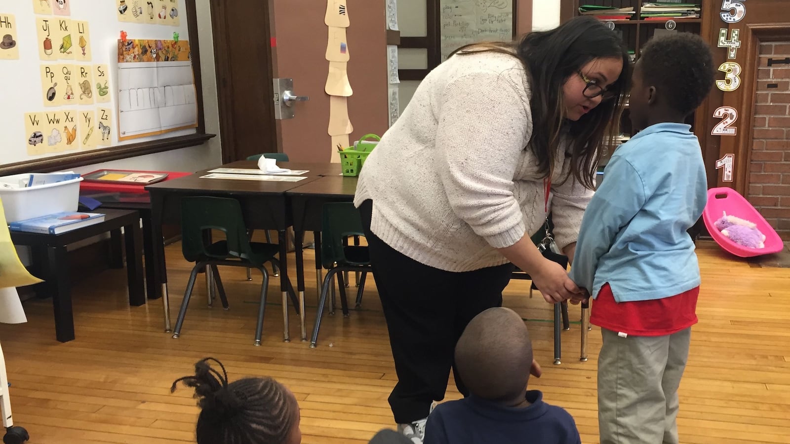 Kindergarten teacher Stefanie Kovaleski speaks with a student at Detroit's Bethune Elementary-Middle School.