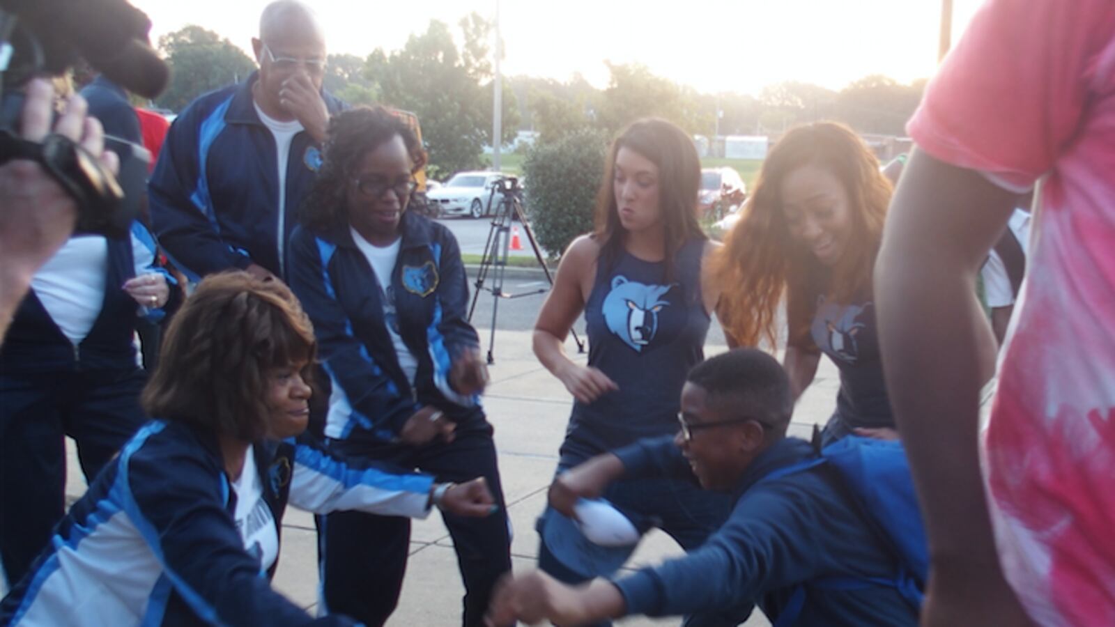 A student at A. Maceo Walker Middle School and a volunteer with the Memphis Grizzlies  celebrate the start of a school attendance campaign through a partnership of the NBA team, Shelby County Schools and Seeding Success.