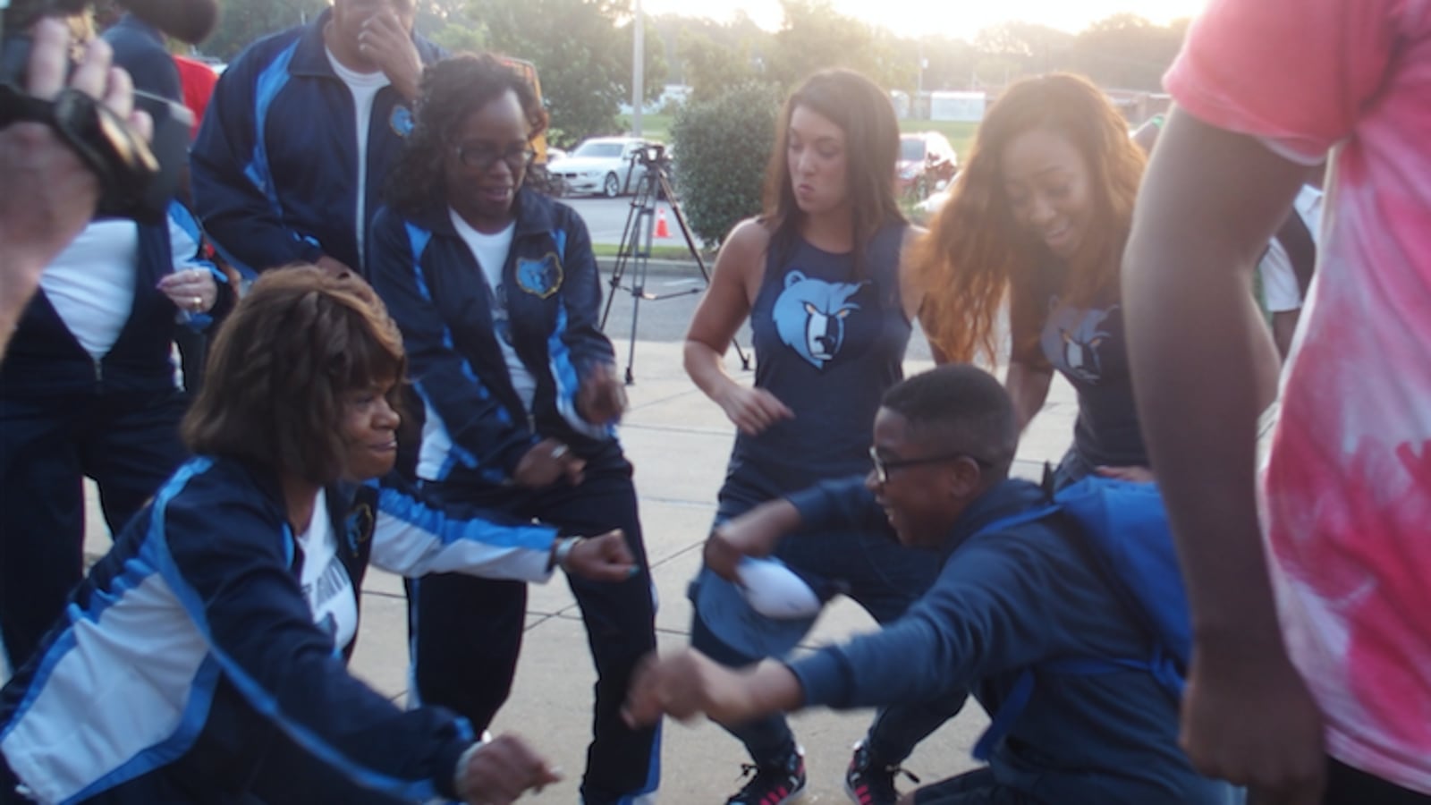 A student at A. Maceo Walker Middle School and a volunteer with the Memphis Grizzlies  celebrate the start of a school attendance campaign through a partnership of the NBA team, Shelby County Schools and Seeding Success.